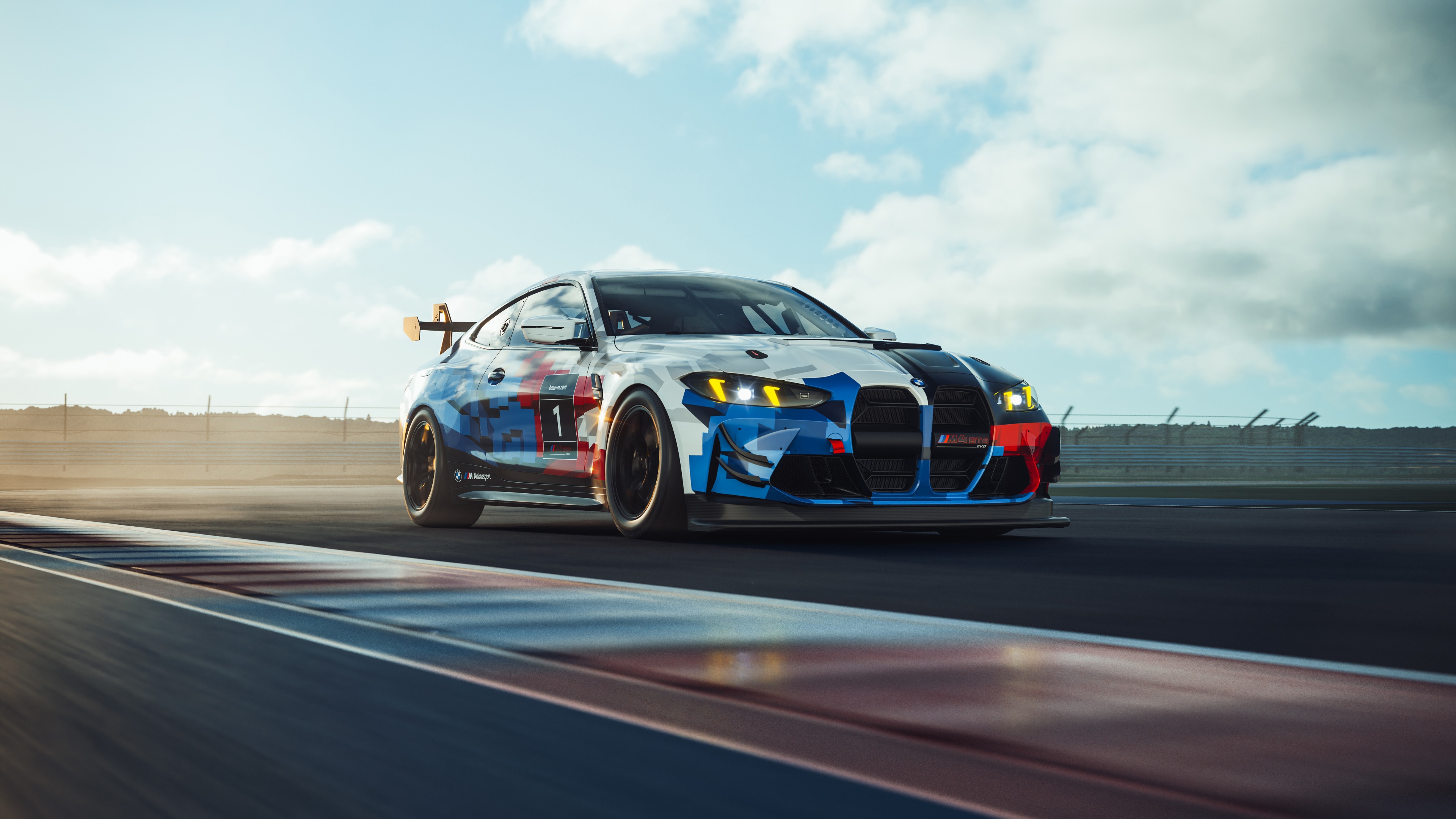 A detailed view of a BMW M4 GT4 EVO racing car navigating a corner on a professional race circuit.