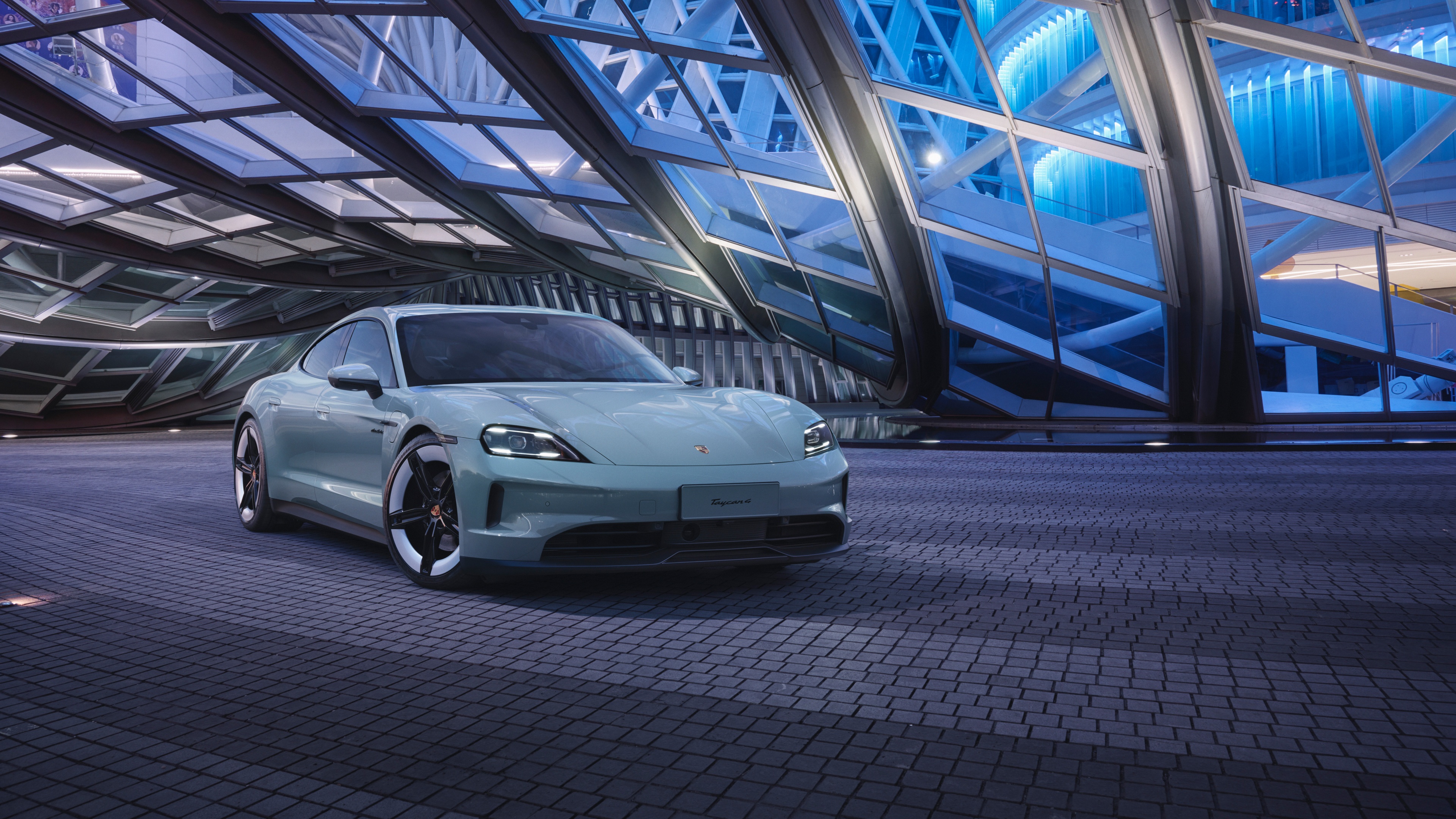 A high-resolution, professional shot of a 2024 Porsche Taycan electric sports car.