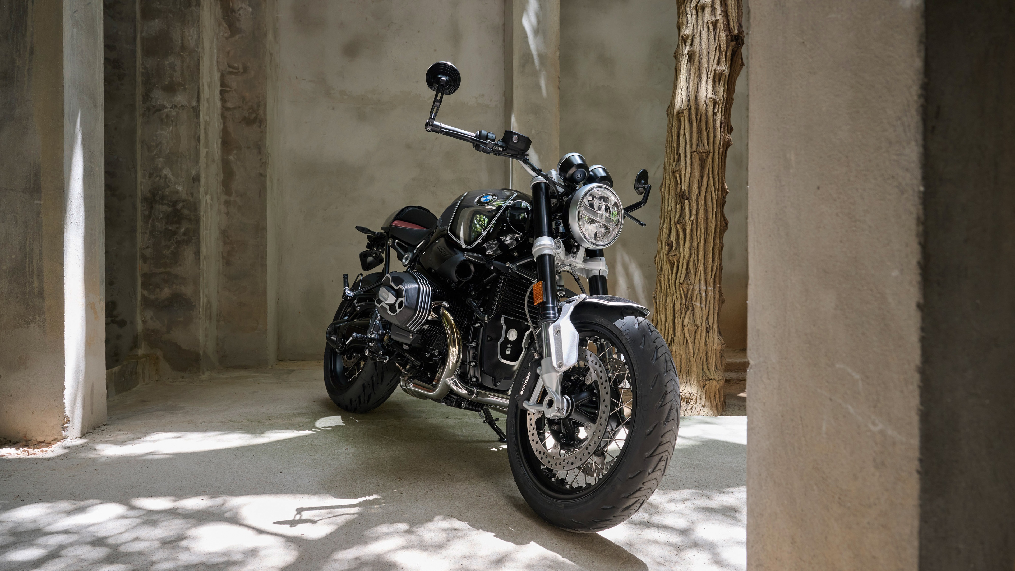 A detailed view of a BMW R nineT cafe racer motorcycle, blending retro style with modern classic naked bike aesthetics.