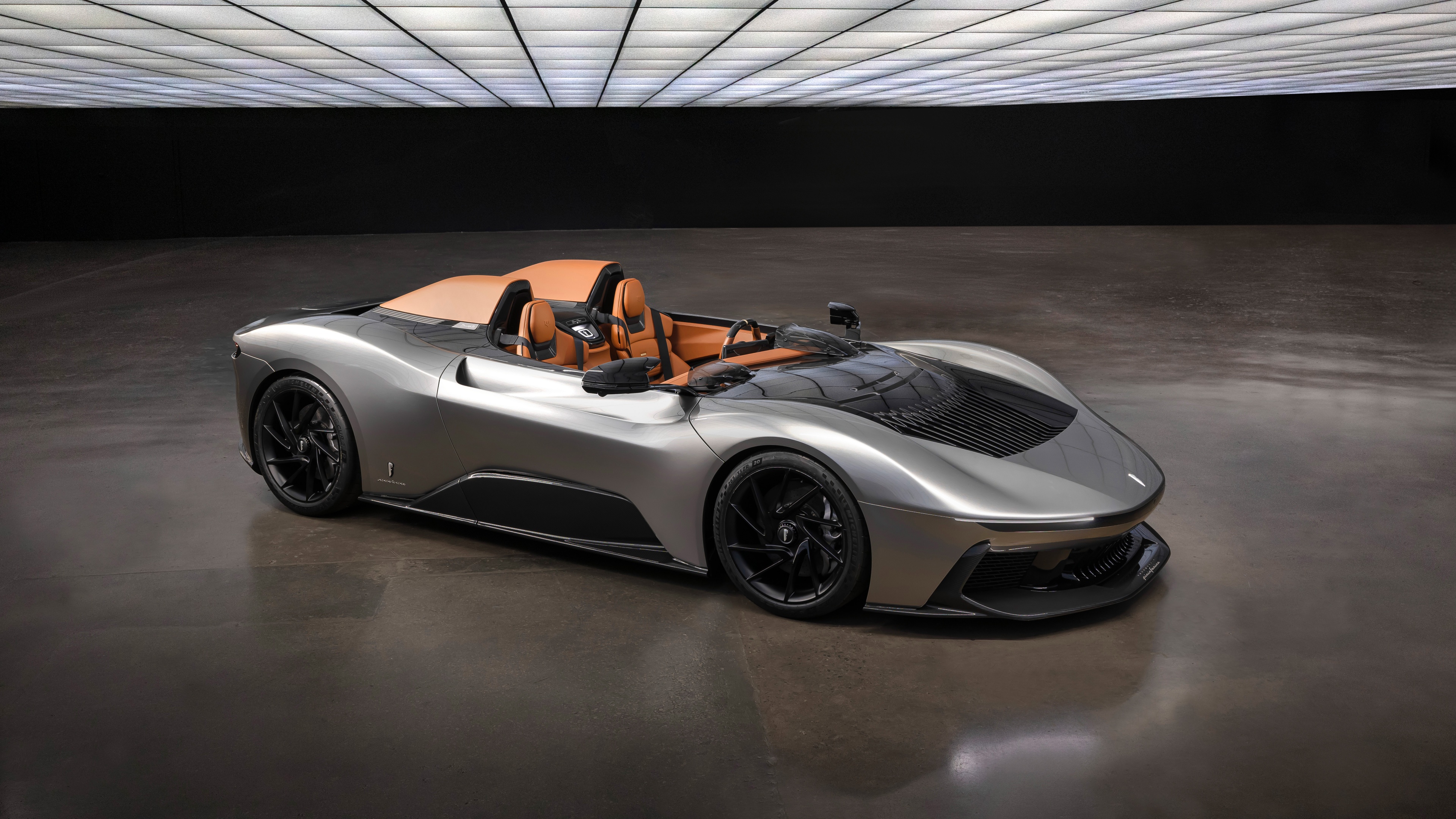 A high-resolution, detailed shot of a modern electric supercar with glowing light accents and aerodynamic bodywork.