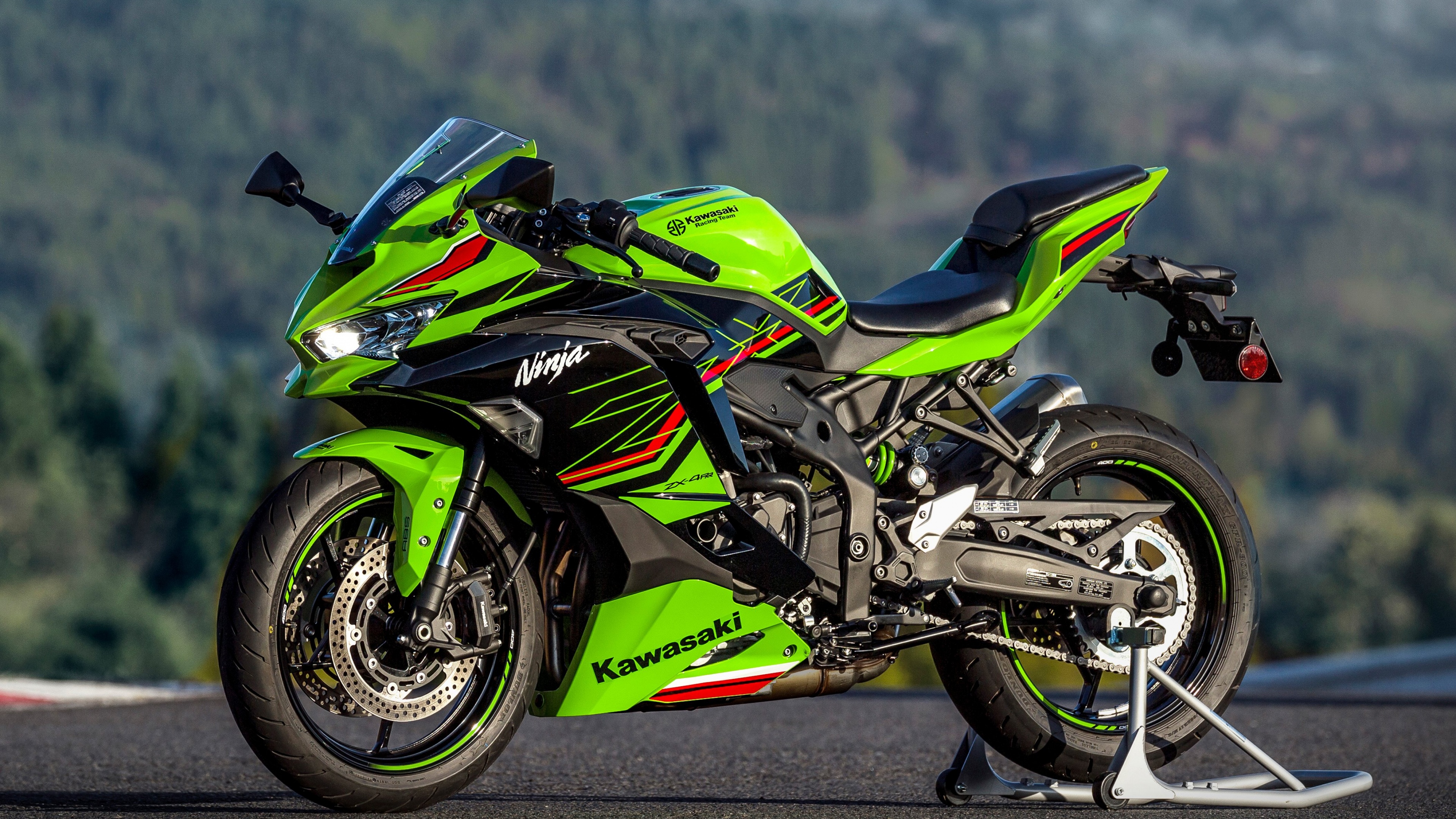 A detailed view of a Kawasaki Ninja ZX-4RR sports motorcycle in lime green and black.