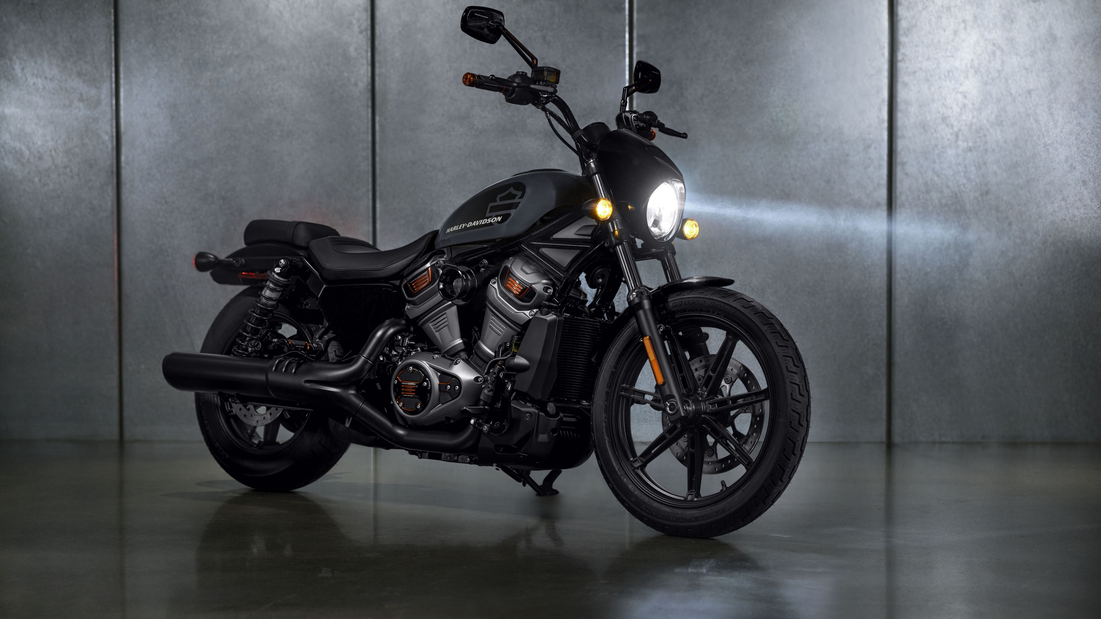 A detailed, high-resolution close-up of a black 2022 Harley-Davidson Nightster cruiser motorcycle.