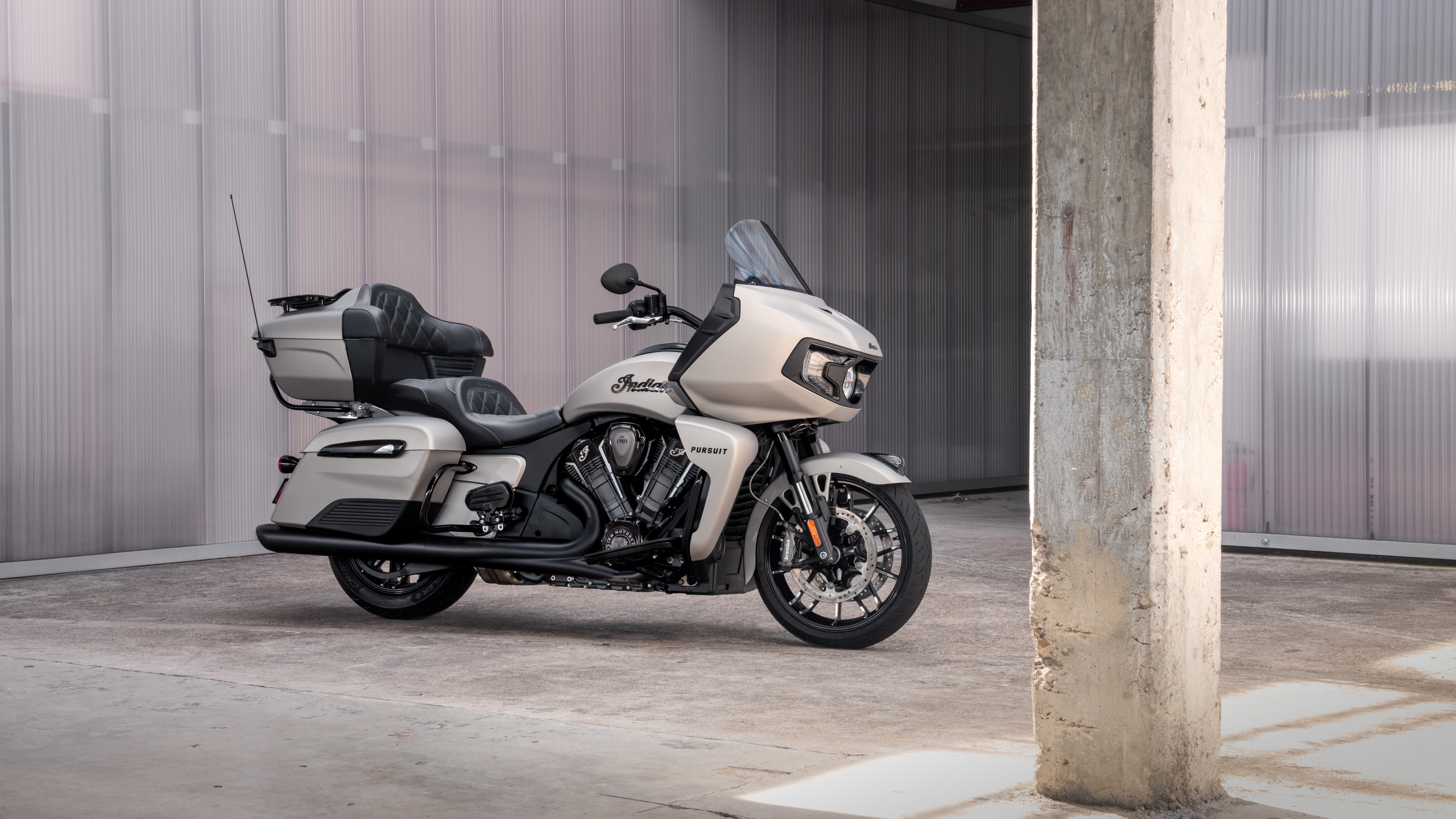 A highly detailed 8K close-up shot of a modern touring motorcycle featuring polished chrome and metallic components.