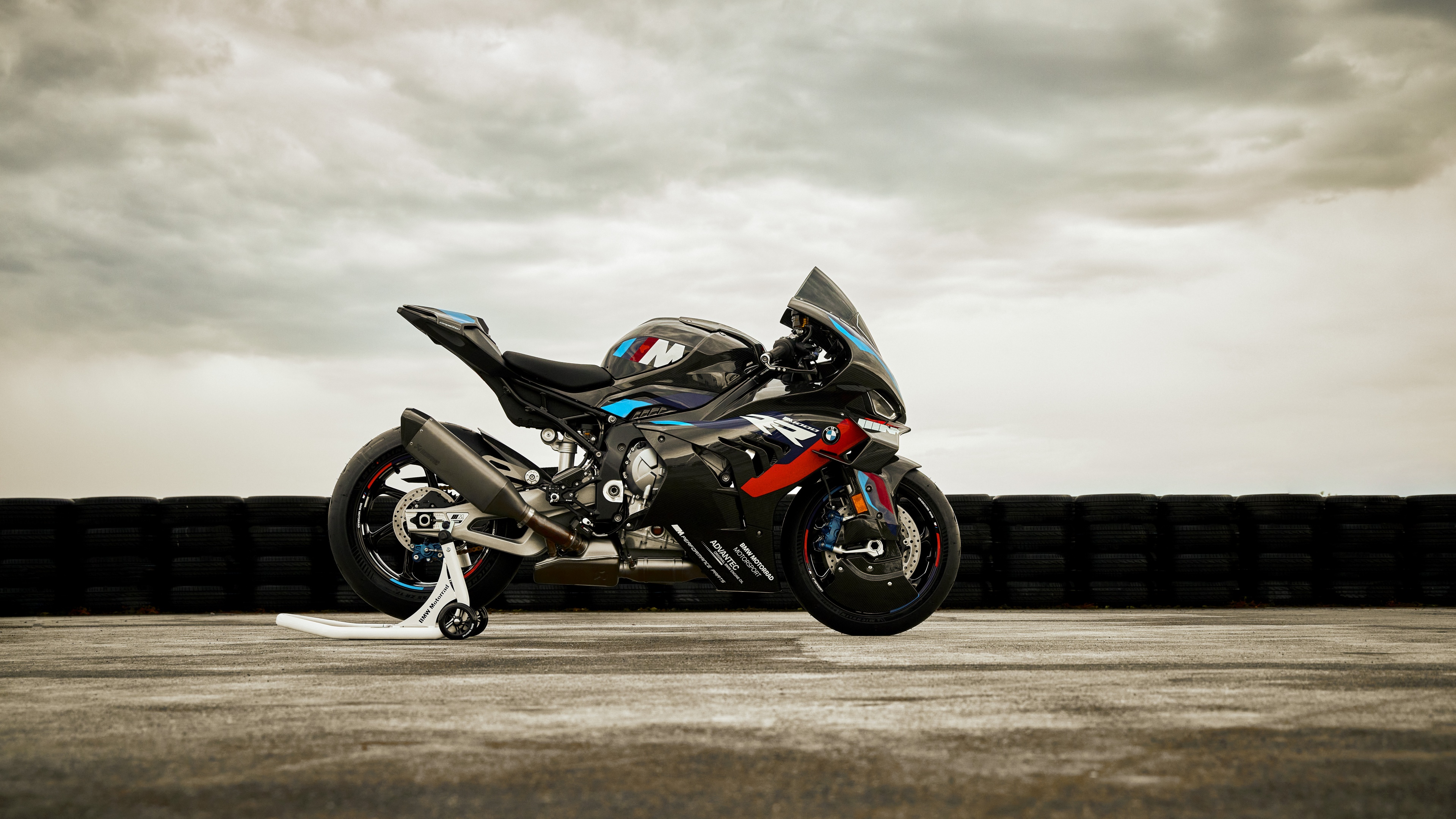 A high-resolution, detailed shot of a 2023 BMW M 1000 RR sports motorcycle featuring aerodynamic wings and carbon fiber details.