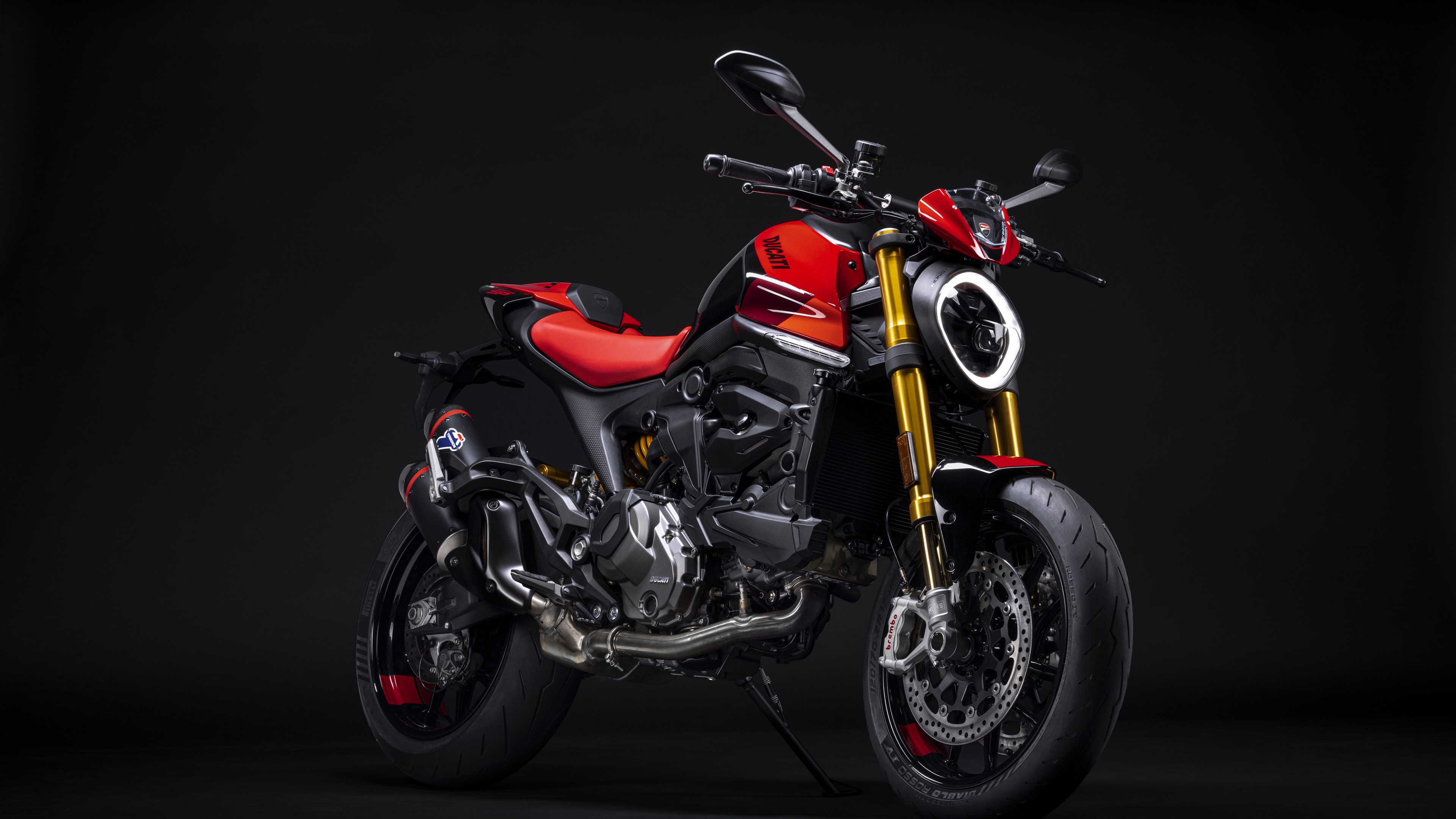 A 2023 Ducati Monster SP sports motorcycle positioned against a dark, minimalist background.