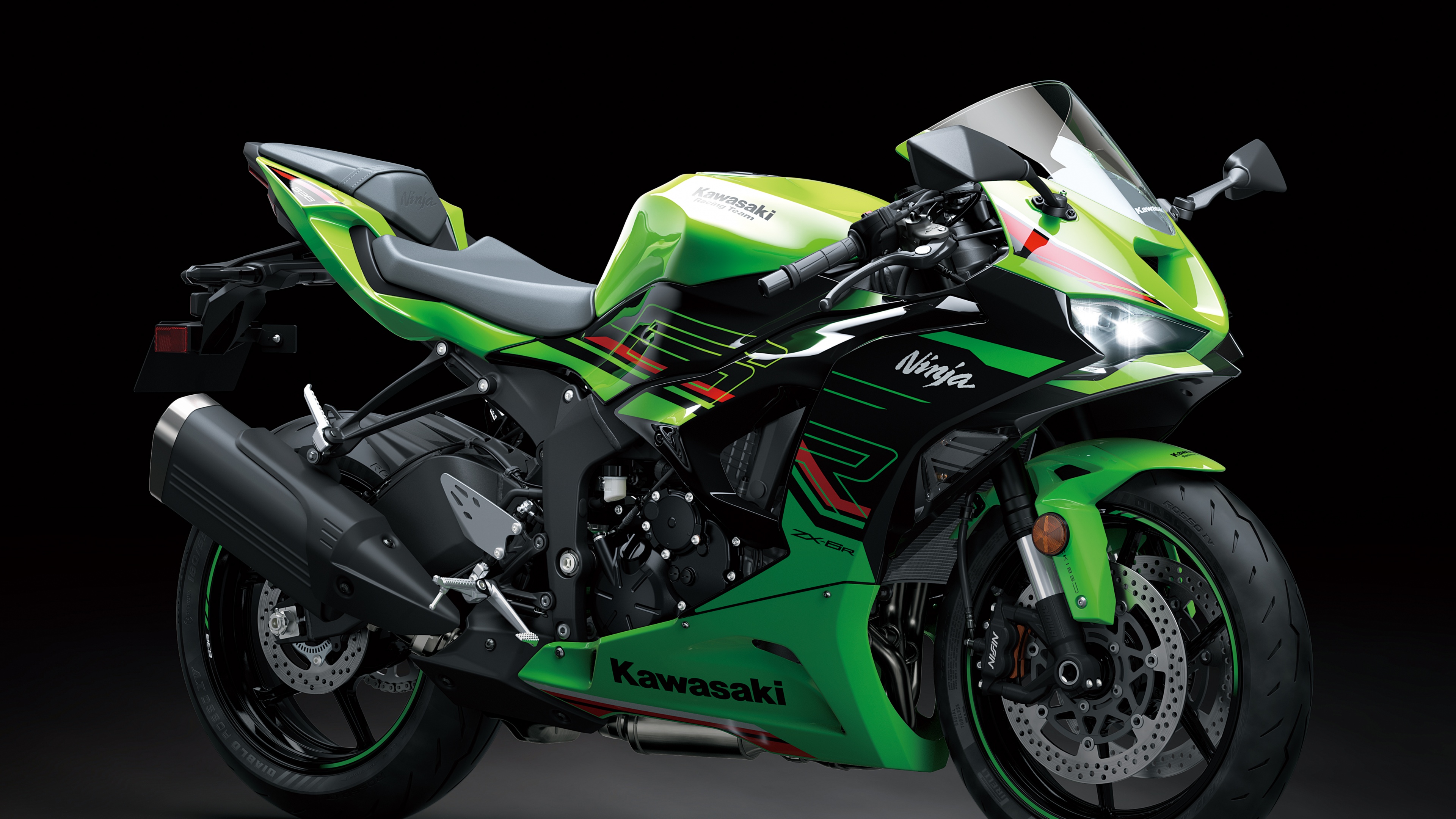 Detailed close-up of a 2024 Kawasaki Ninja ZX-6R sports bike against a dark, moody background.
