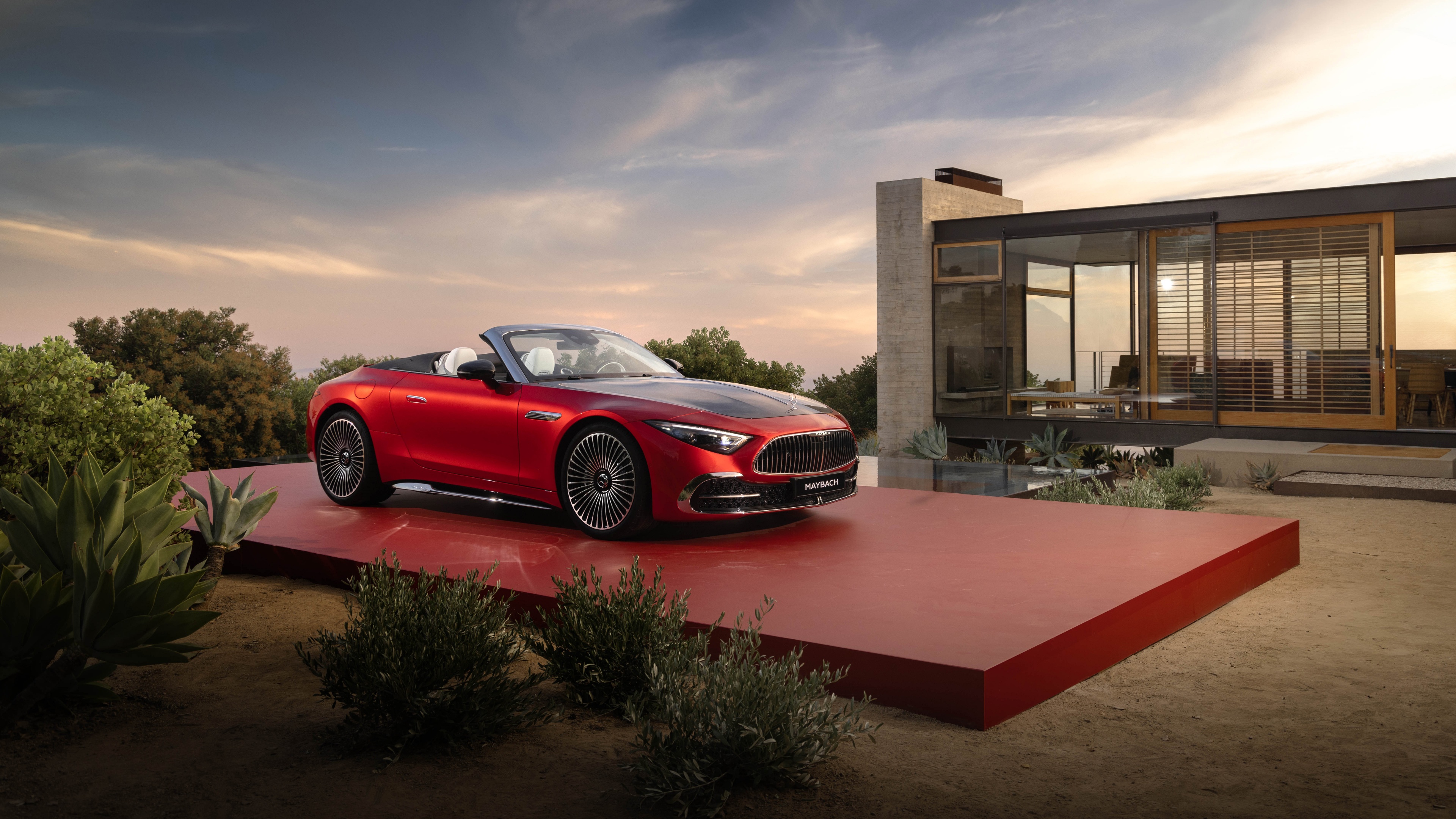 A stunning, high-detail view of a vibrant red 2024 Mercedes-Maybach SL 680 luxury convertible.