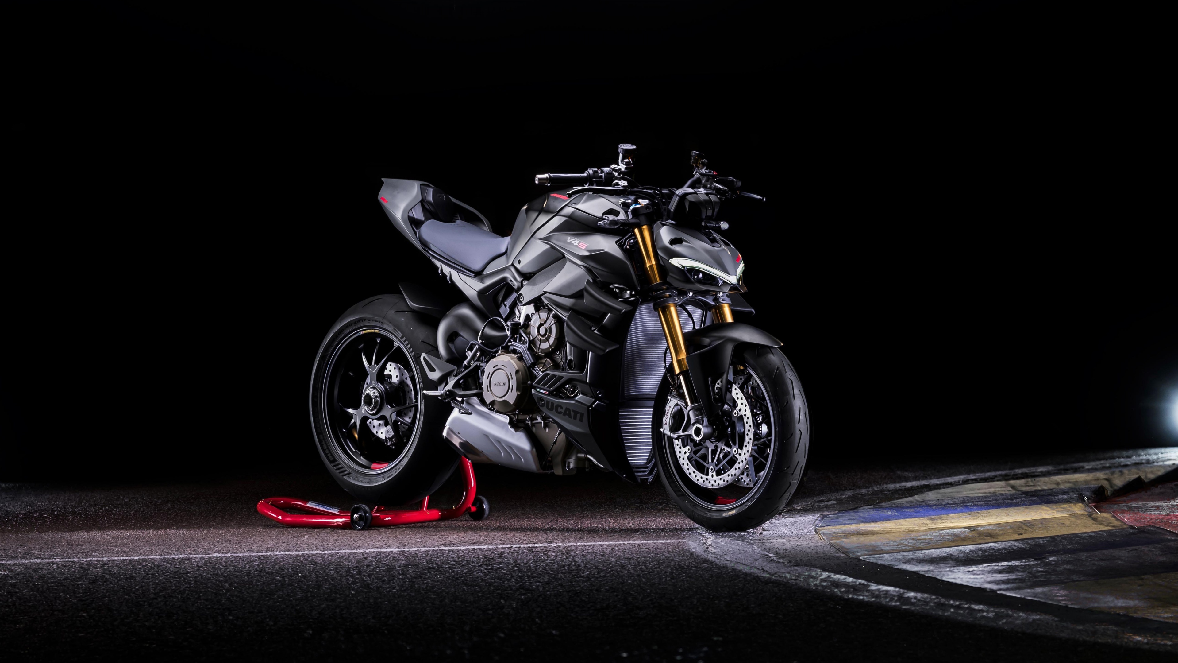 The 2023 Ducati Streetfighter V4 S sports motorcycle positioned on a dark, professional race track.