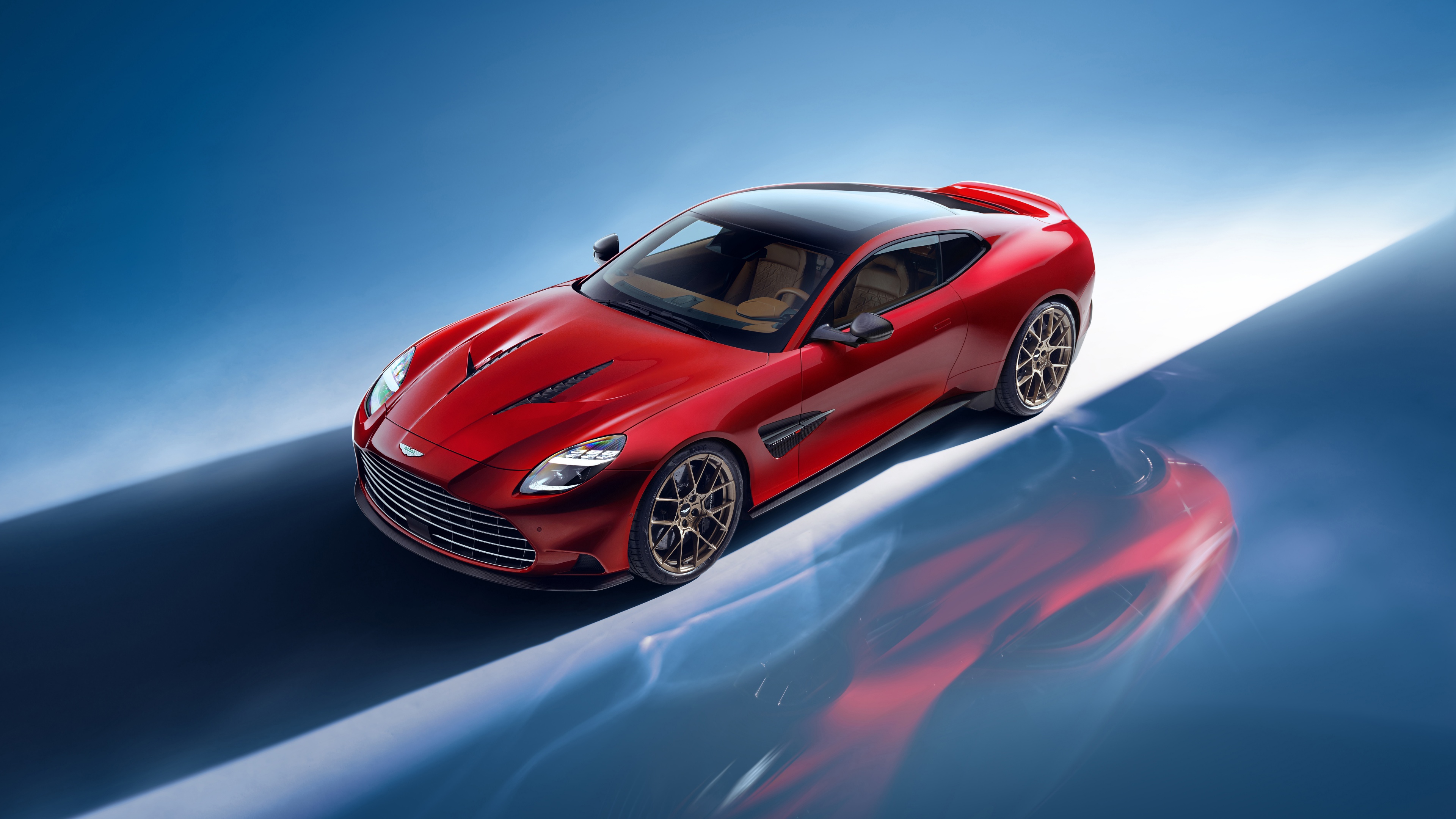 A high-detail, vibrant red Aston Martin Vanquish luxury sports car.