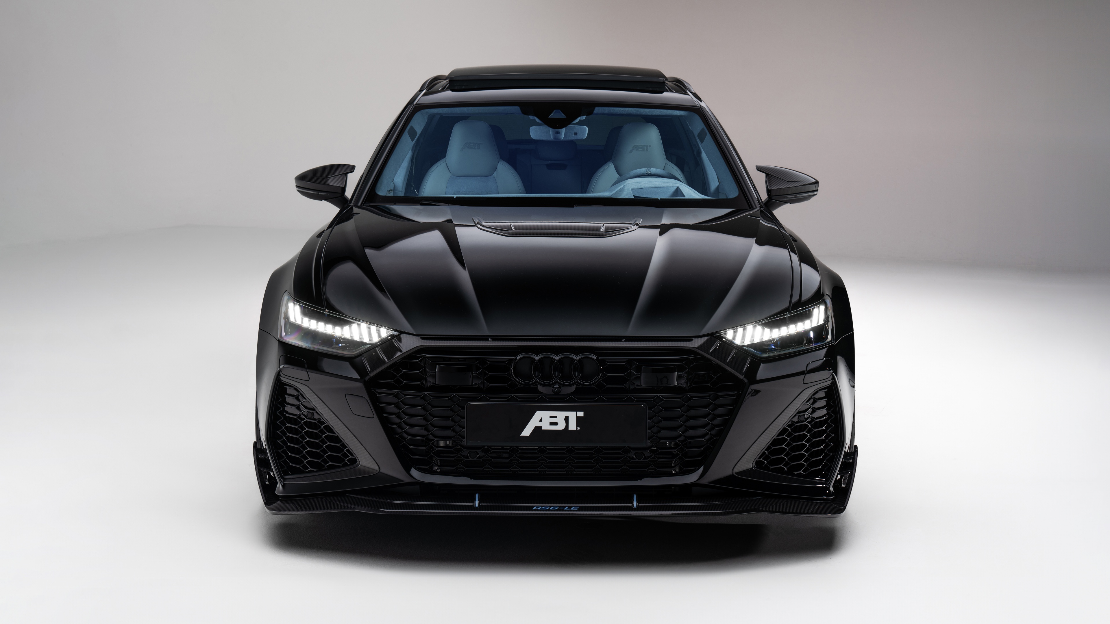 A collection of sleek, high-gloss black luxury cars with modern 2024 designs.