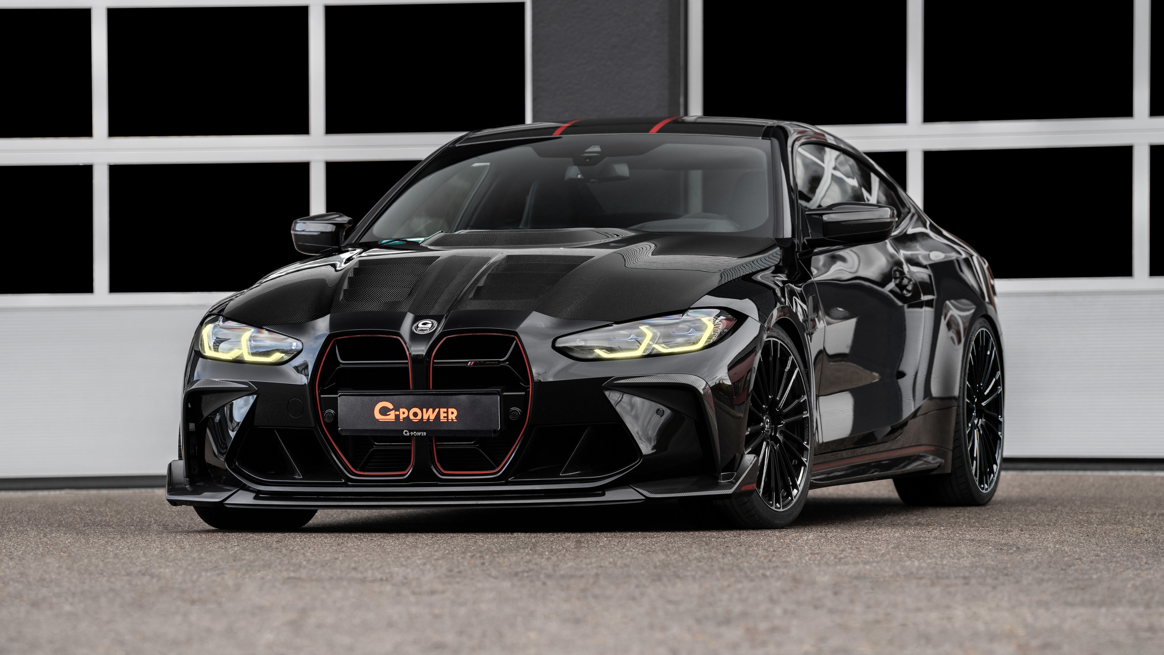 A close-up, high-resolution shot of a black G-Power tuned BMW M4 CSL.