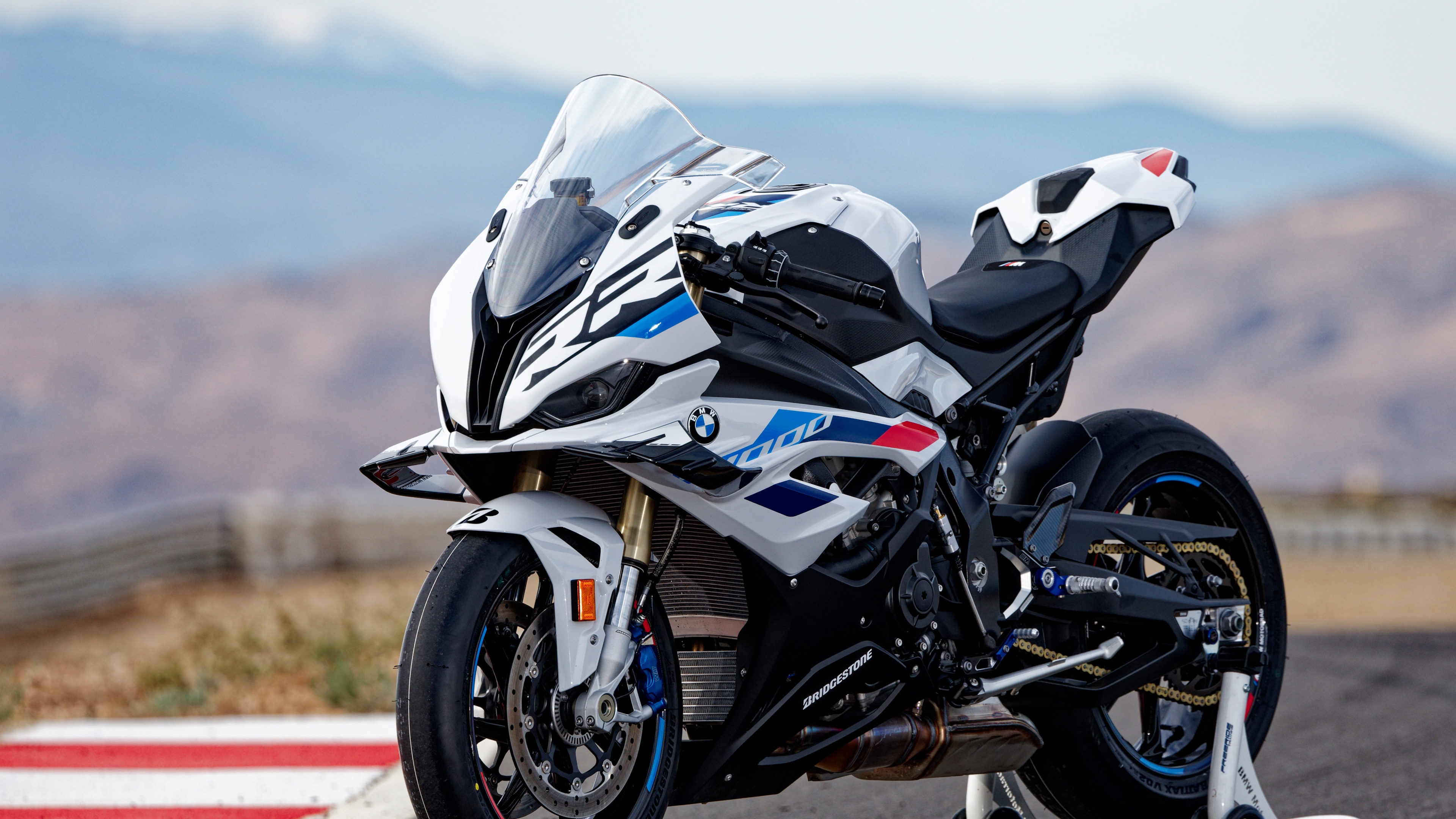A high-detail shot of a BMW S 1000 RR superbike on a professional racing circuit.