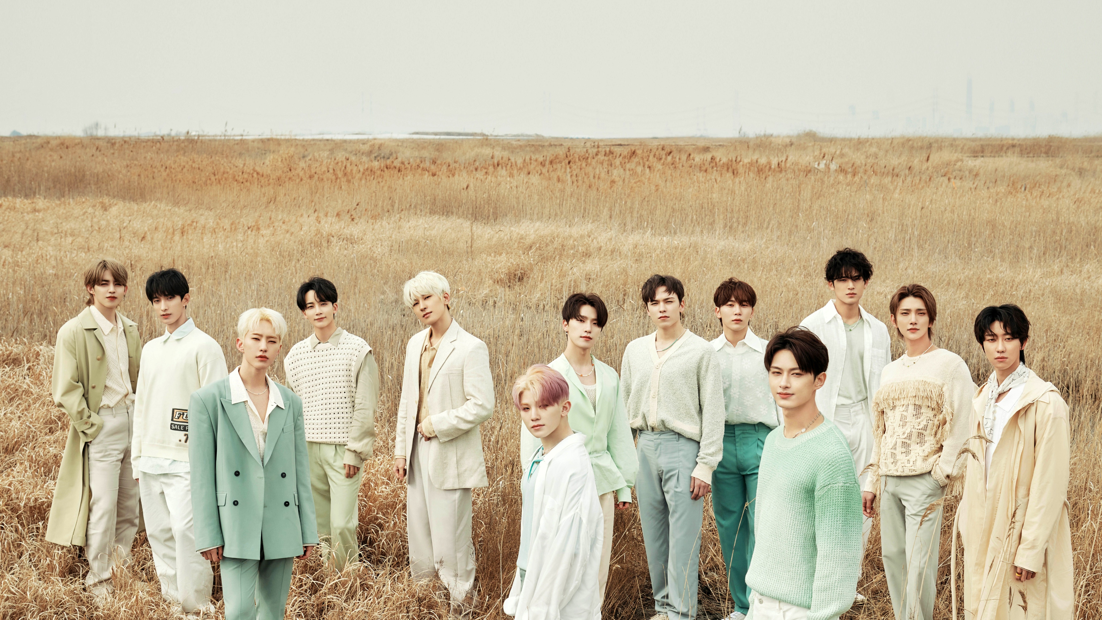 A cinematic and high-resolution group portrait of the South Korean K-Pop boy band SEVENTEEN.