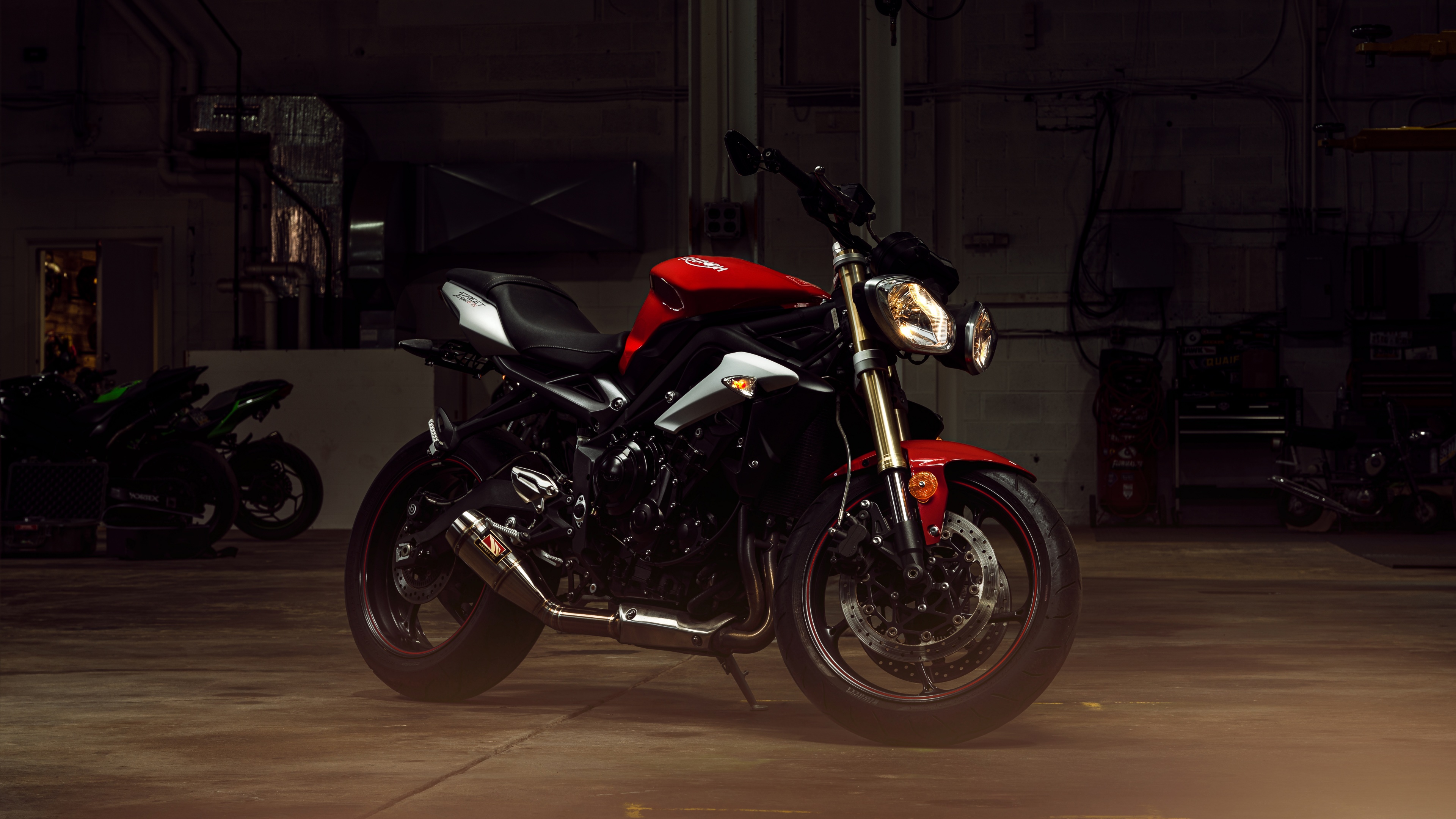 A high-detail, professional shot of a Triumph Speed Triple sports motorcycle featuring its sleek design and engine components.