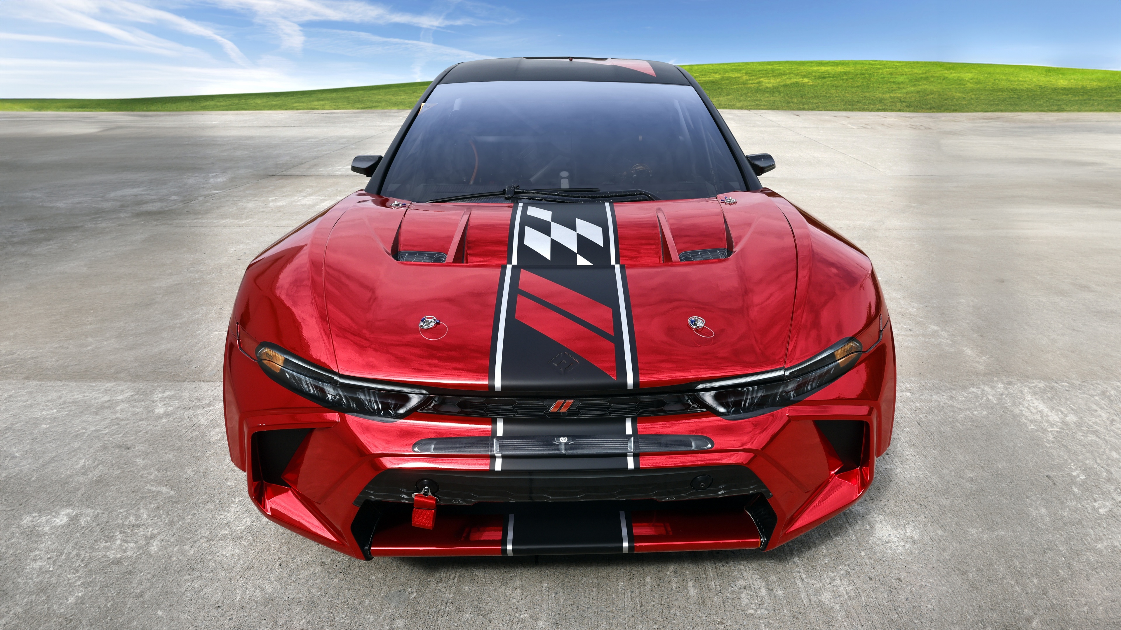 A high-detail close-up of a sleek, bright red 2024 Dodge Hornet.