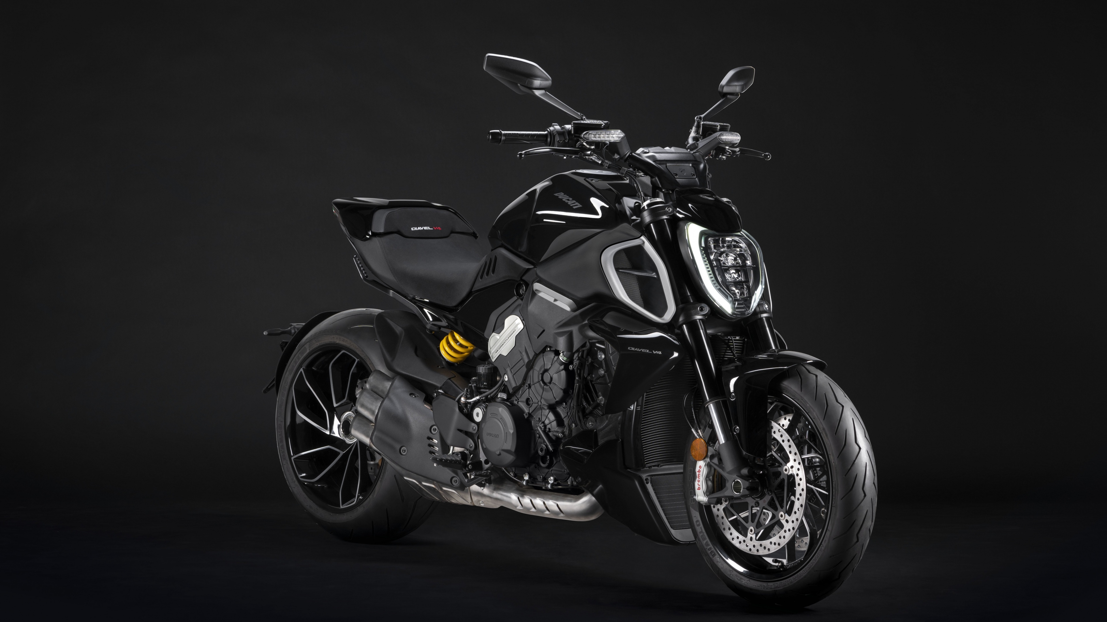 A high-resolution close-up of a 2023 Ducati Diavel V4 muscle cruiser motorcycle against a dark, moody background.