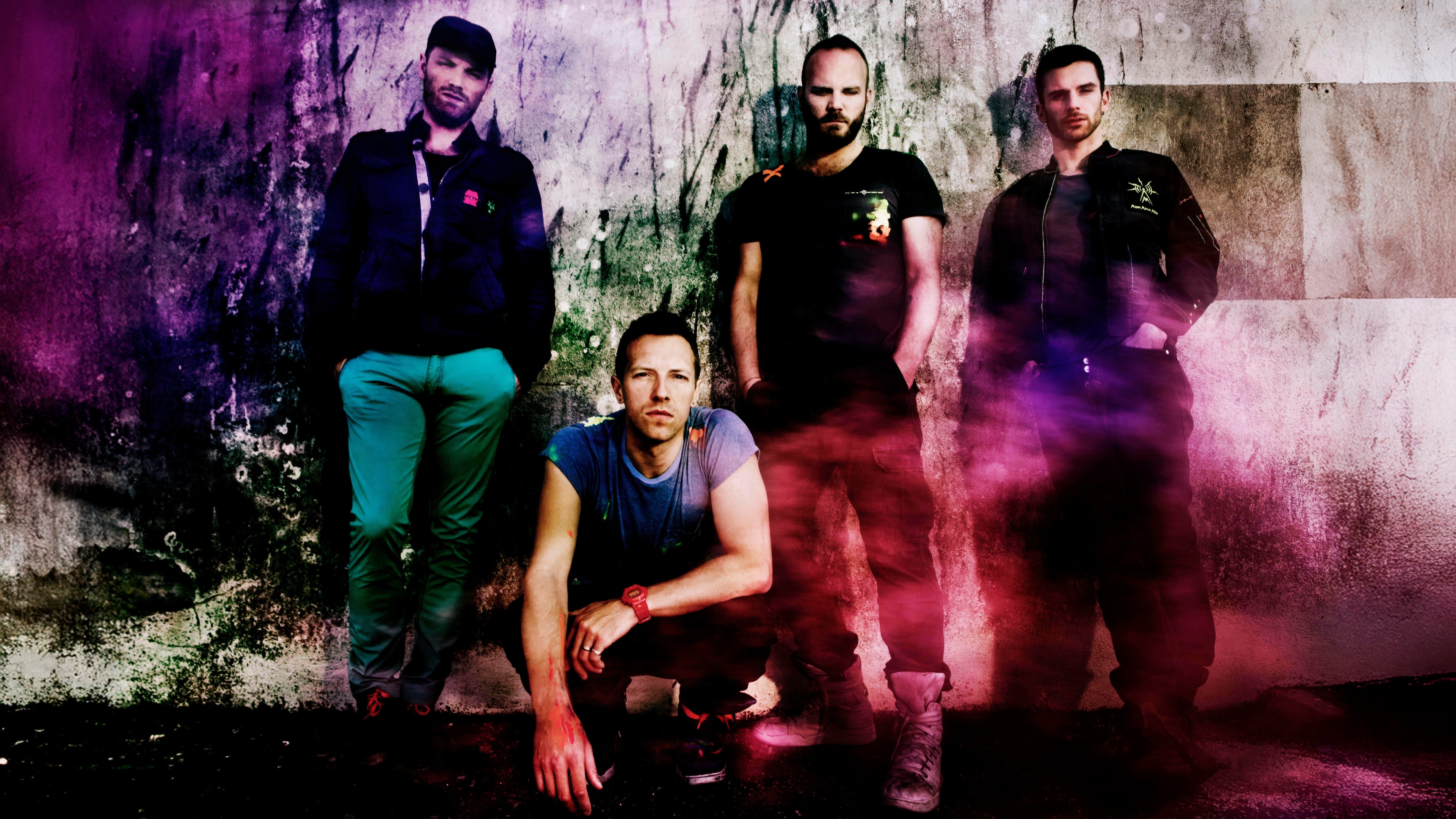 A cinematic grunge-style portrait of the rock band Coldplay featuring Chris Martin, Jonny Buckland, Guy Berryman, and Will Champion.