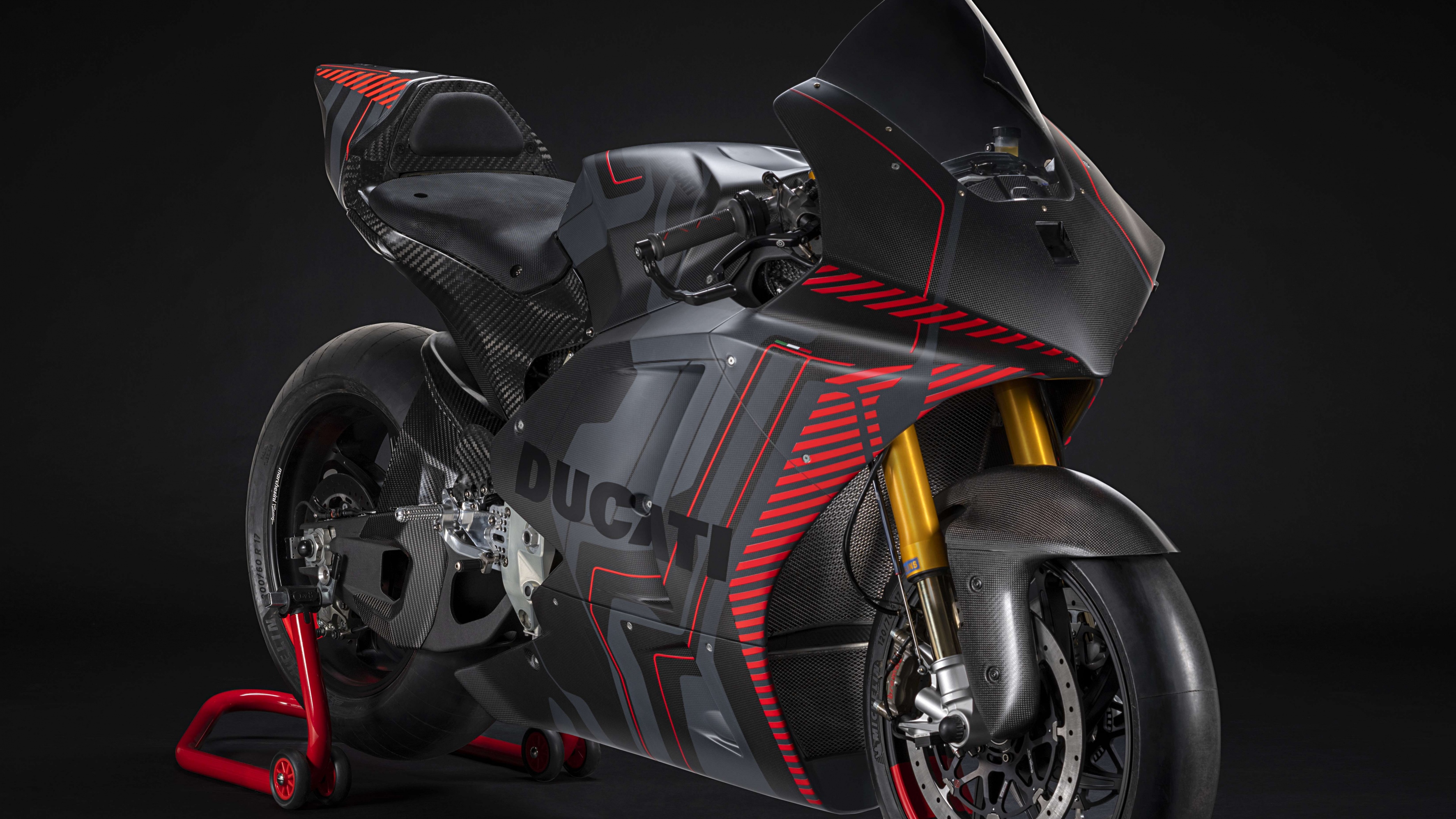 A sleek Ducati V21L MotoE electric prototype sports bike featuring aerodynamic design against a dark background.