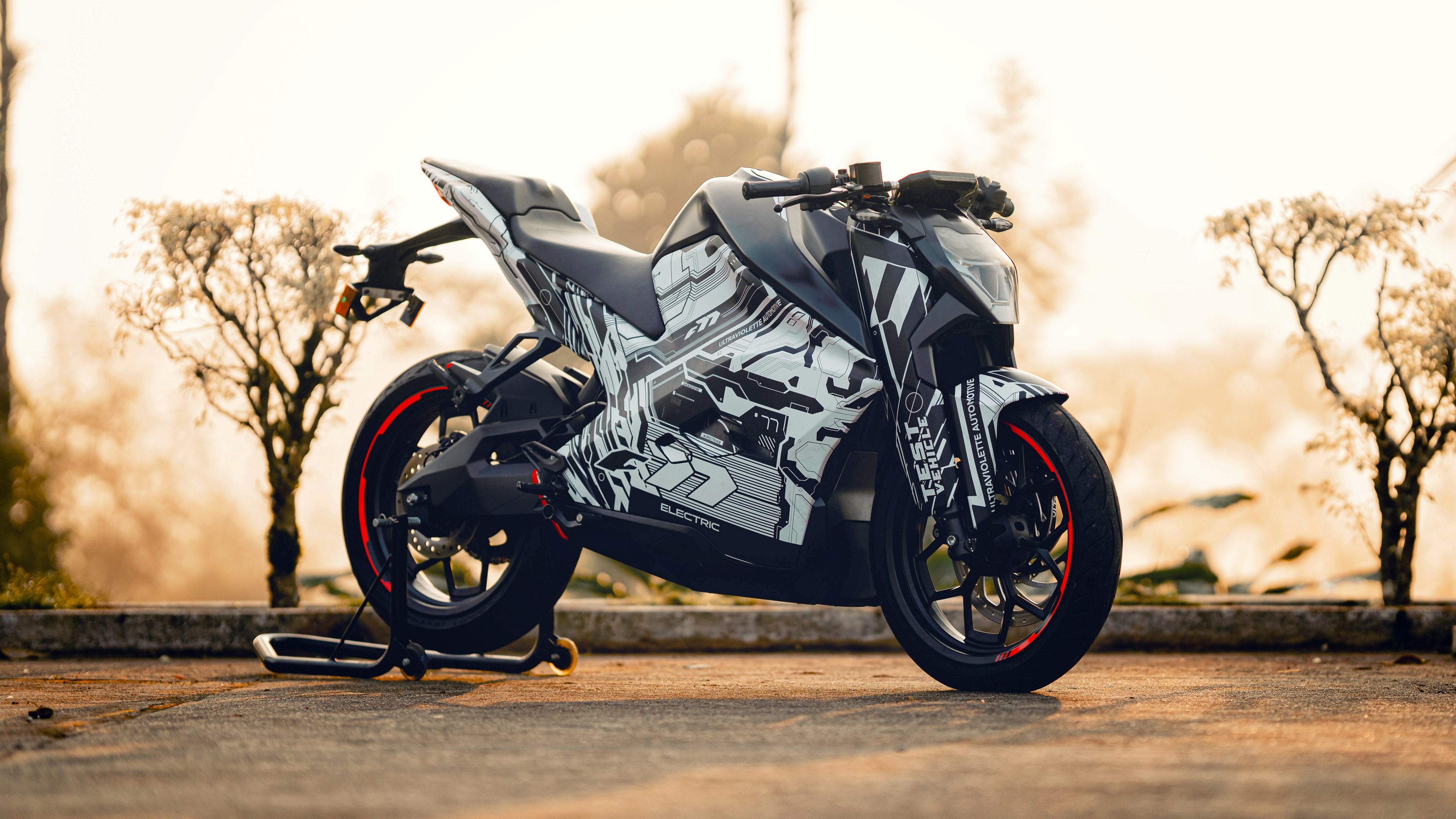 A detailed view of the Ultraviolette F77 electric sports bike featuring a sleek, aerodynamic frame and futuristic design.