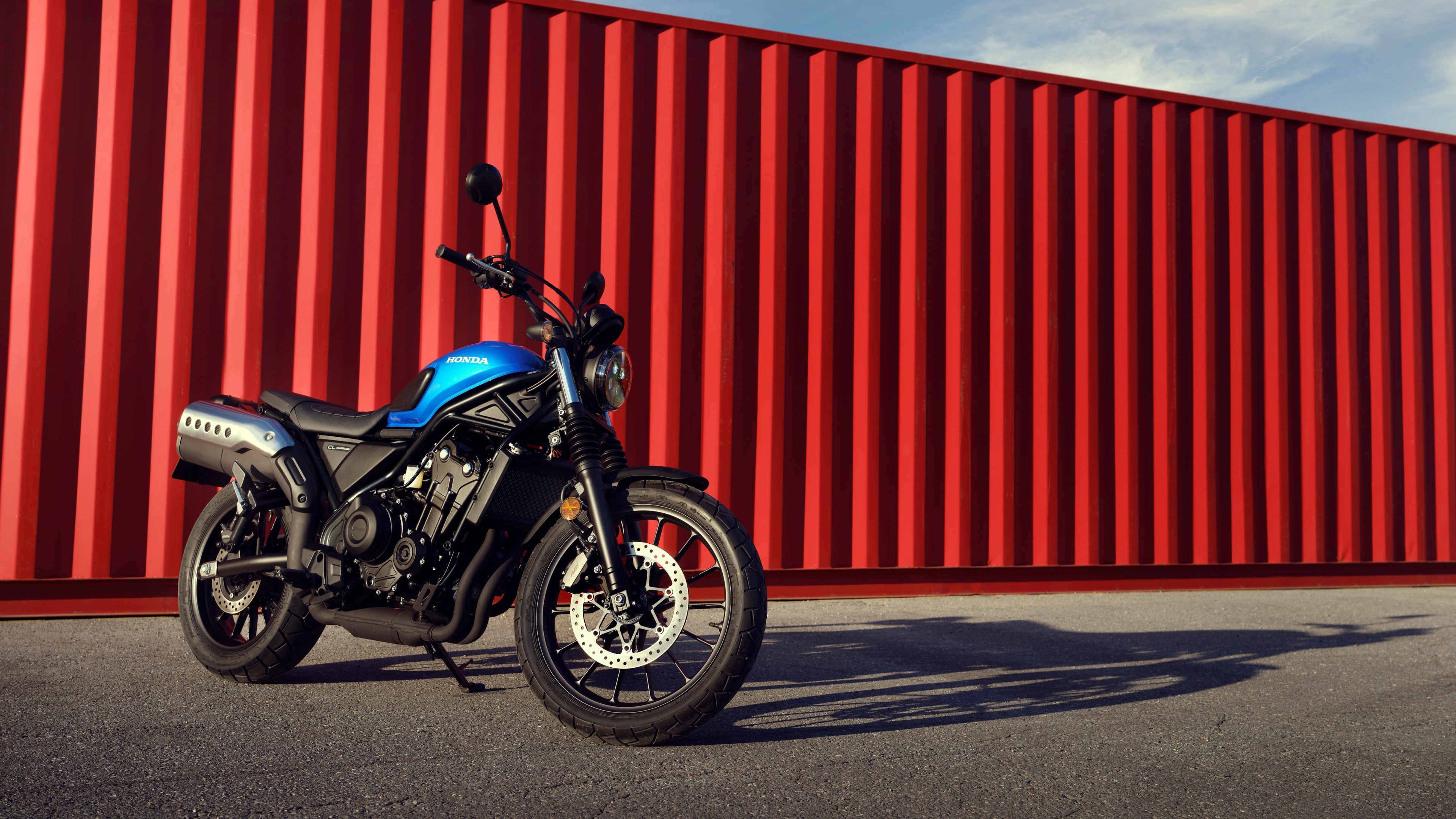 A group of classic retro-style motorcycles parked together, showcasing vintage design, metallic finishes, and chrome details.