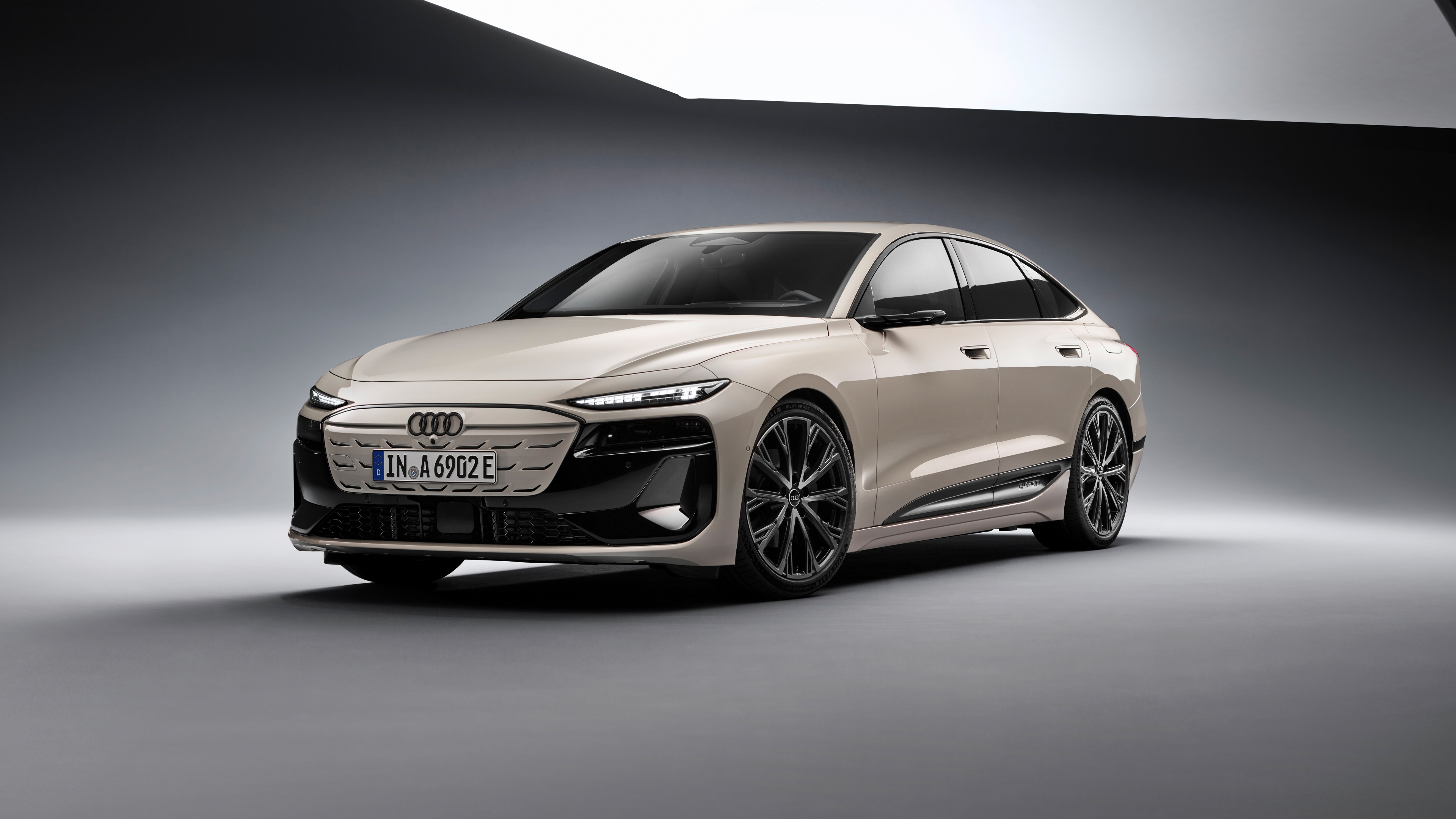 A collection of sleek, modern electric cars driving through a futuristic city street with advanced lighting and aerodynamic designs.