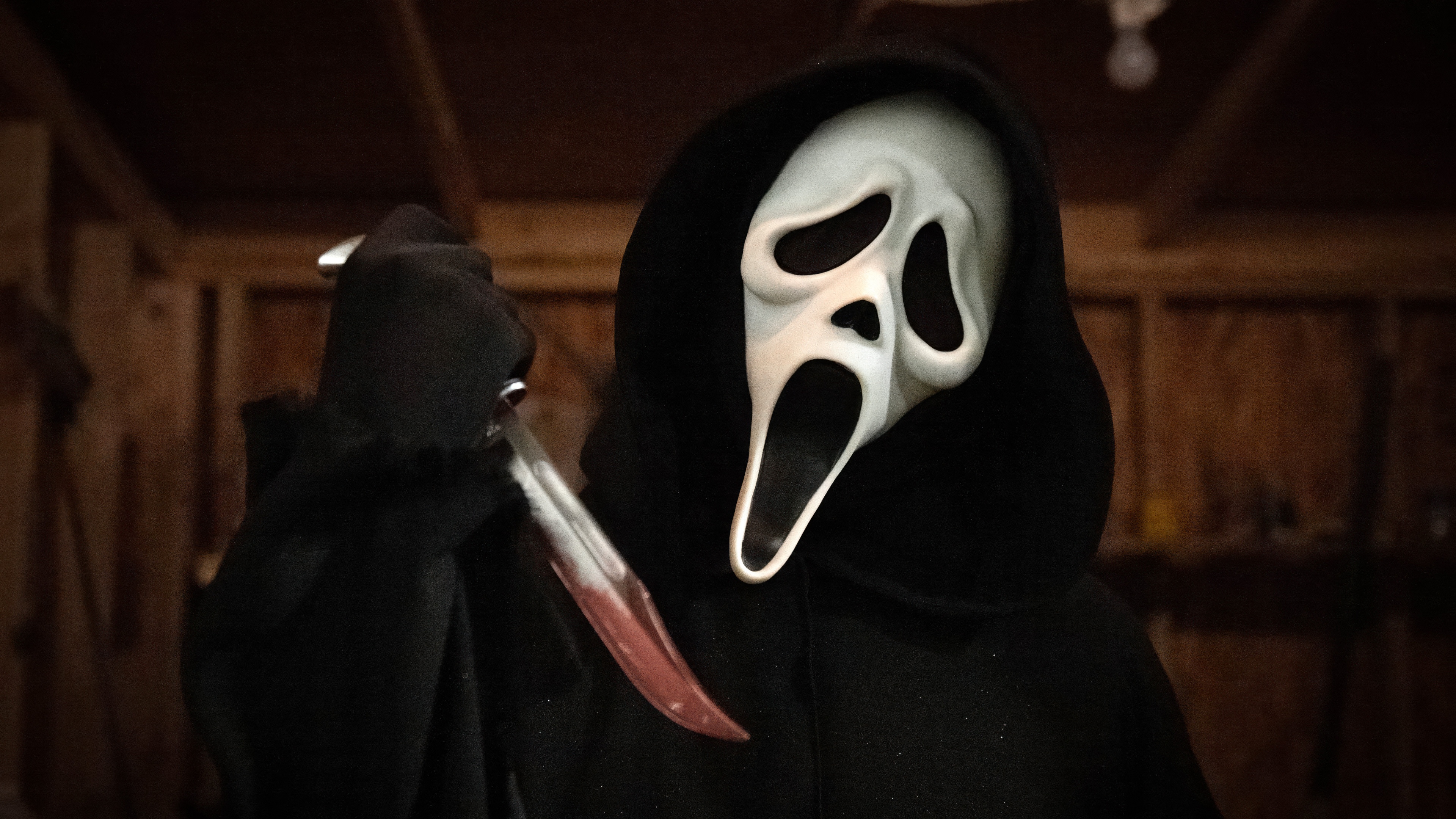 Ghostface from the Scream movie franchise wearing a bloody hooded cloak and iconic mask.