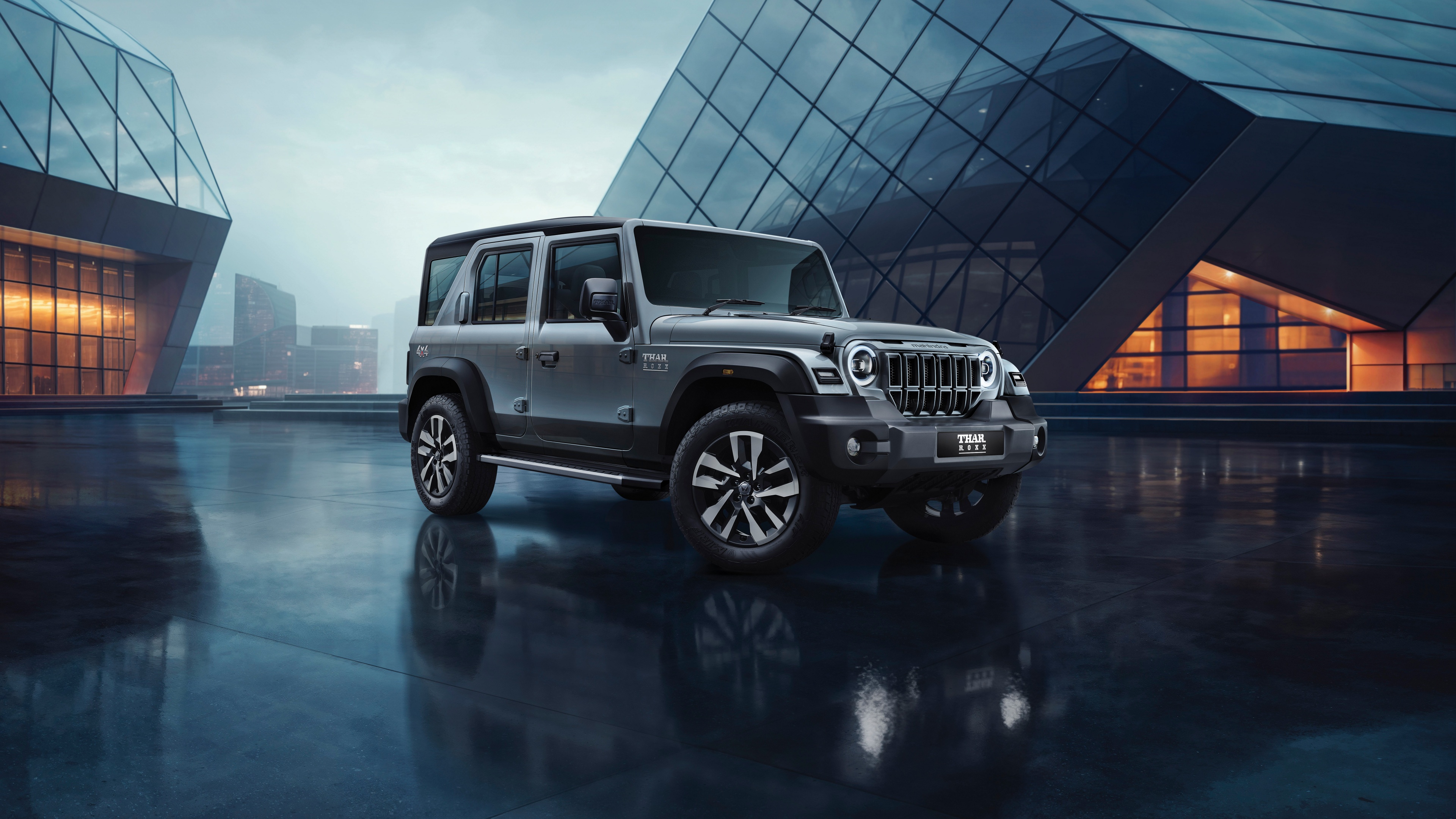 A detailed 8K shot of the Mahindra Thar Roxx off-road SUV navigating rugged, rocky terrain.