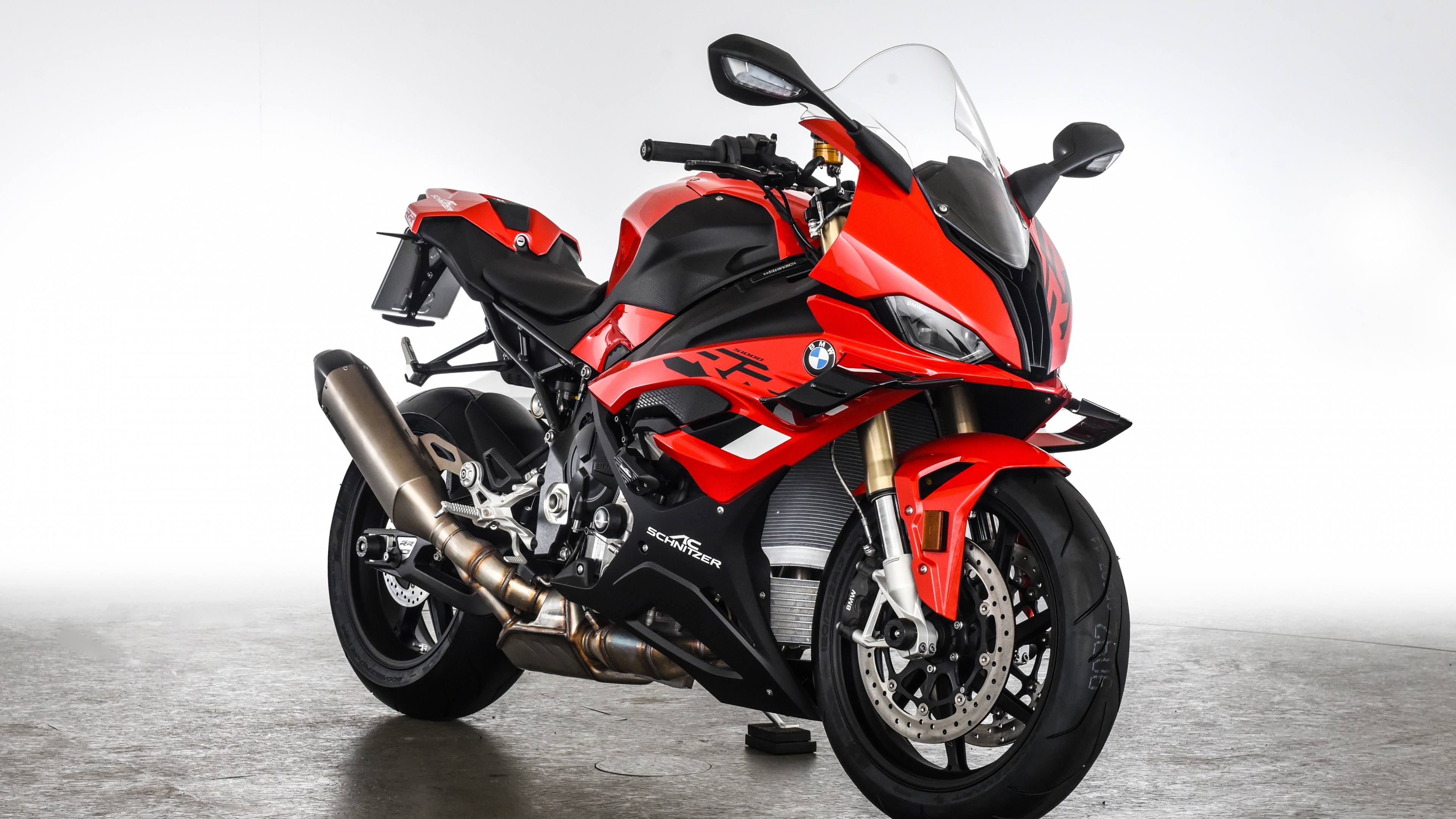 A detailed view of a 2023 BMW S 1000 RR motorcycle equipped with AC Schnitzer performance parts and aerodynamic upgrades.