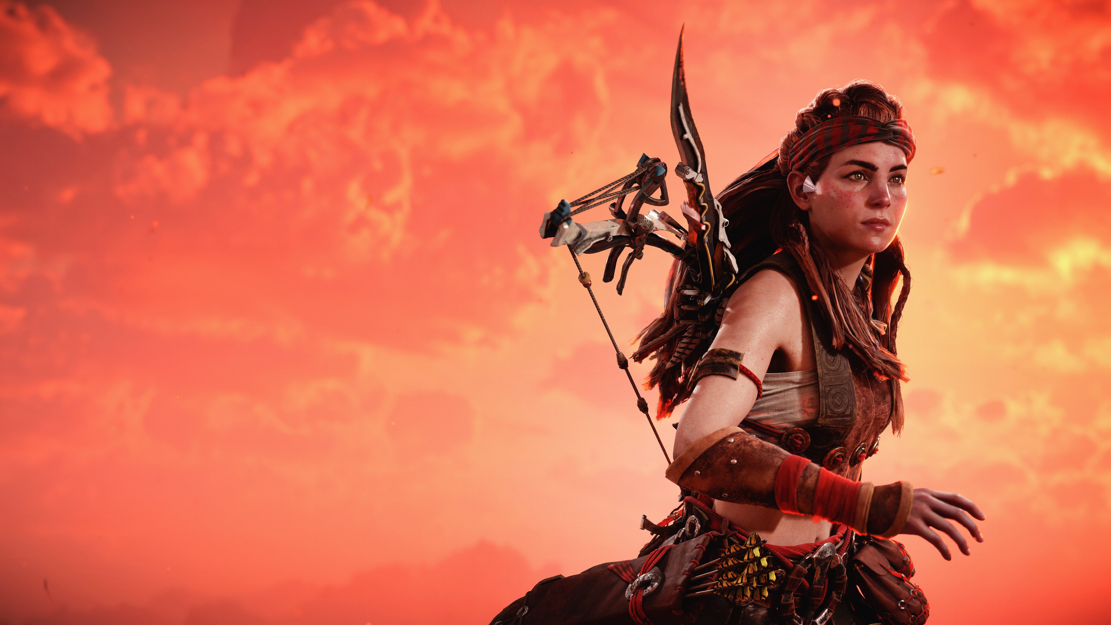A cinematic portrait of Aloy from Horizon Zero Dawn bathed in sunset orange light.