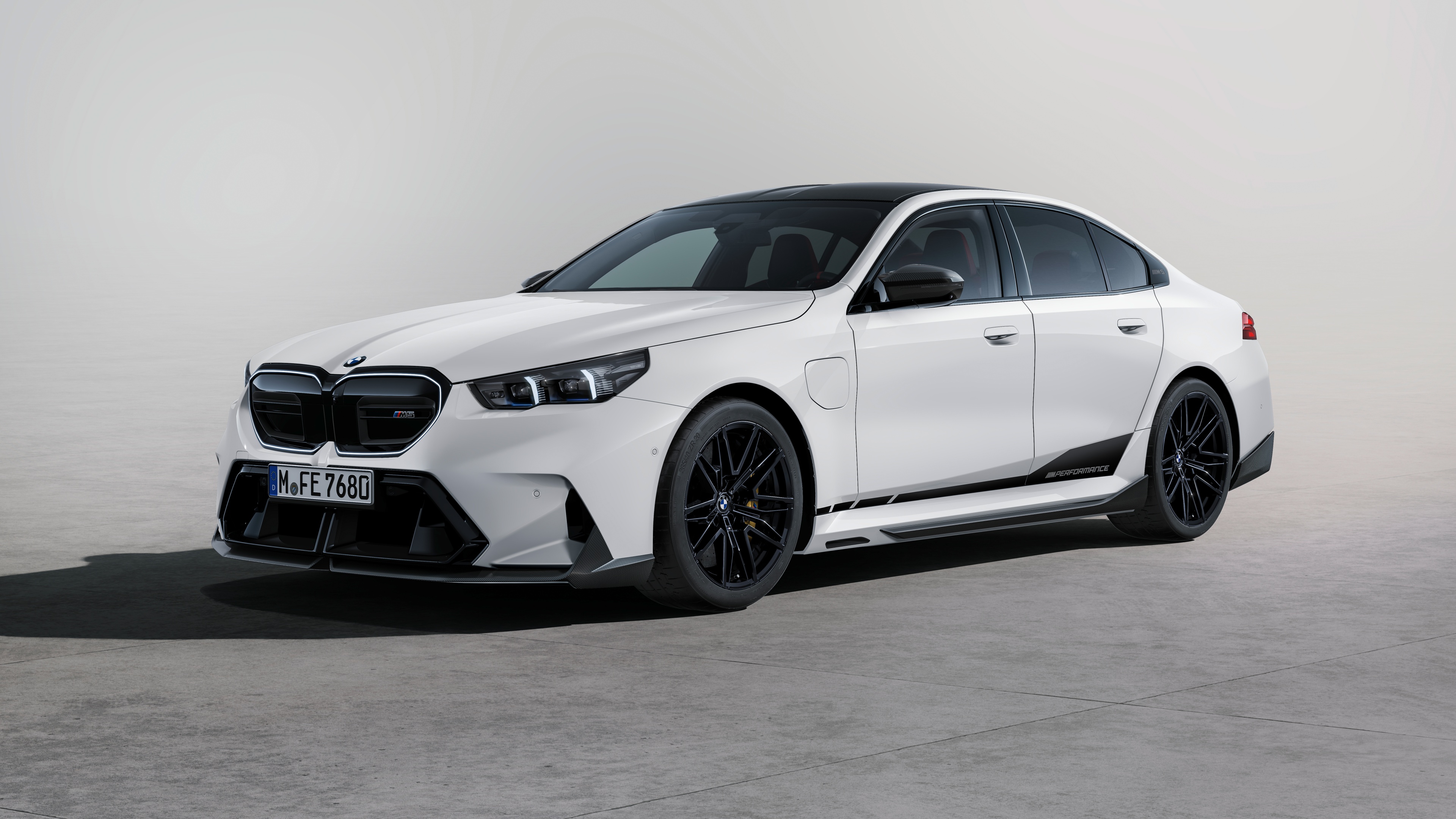 Detailed view of a BMW M5 equipped with M Performance aerodynamic parts and carbon fiber trim