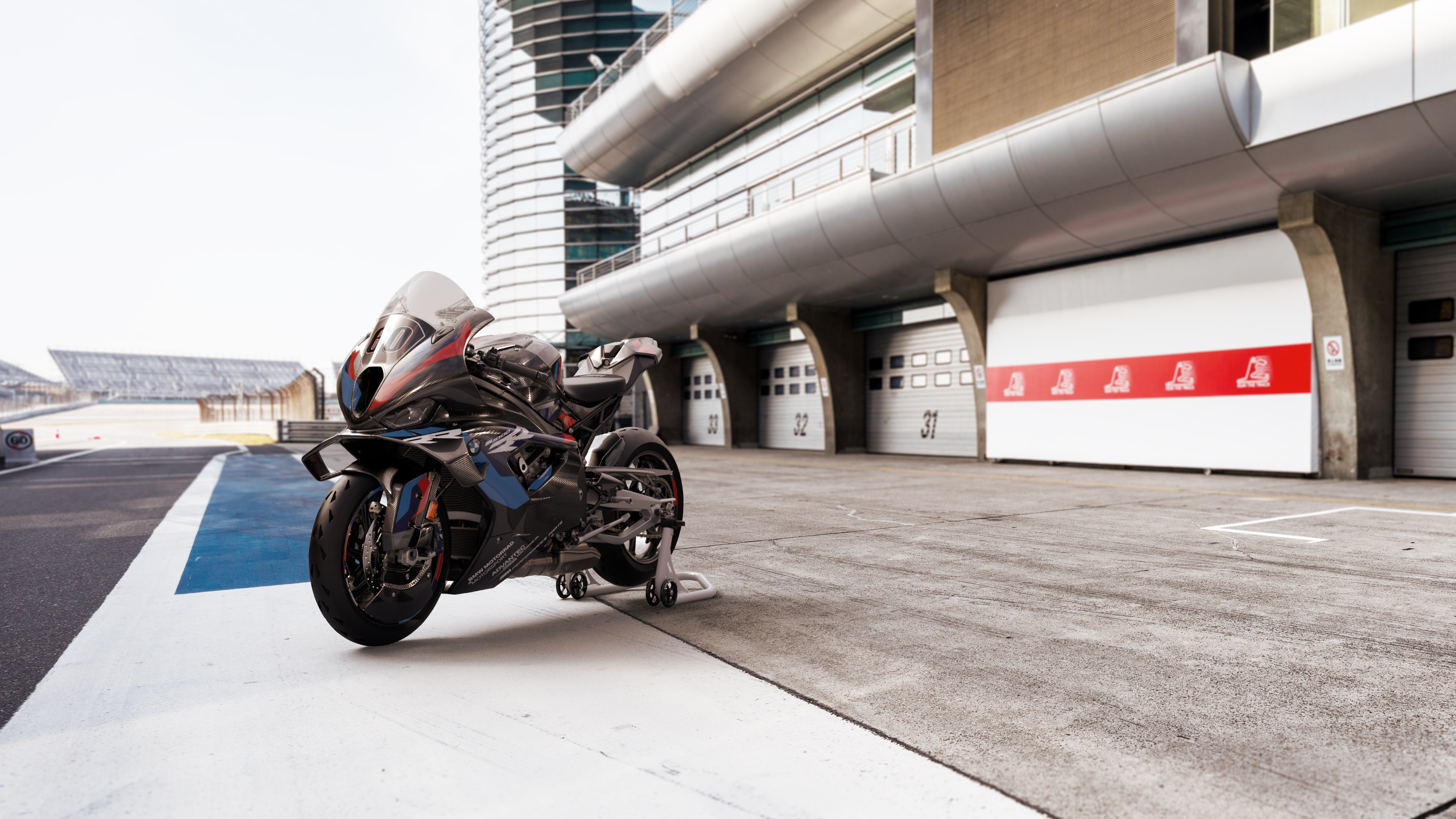 A detailed view of the 2023 BMW M 1000 RR sports motorcycle featuring aerodynamic winglets and signature M-series racing colors.