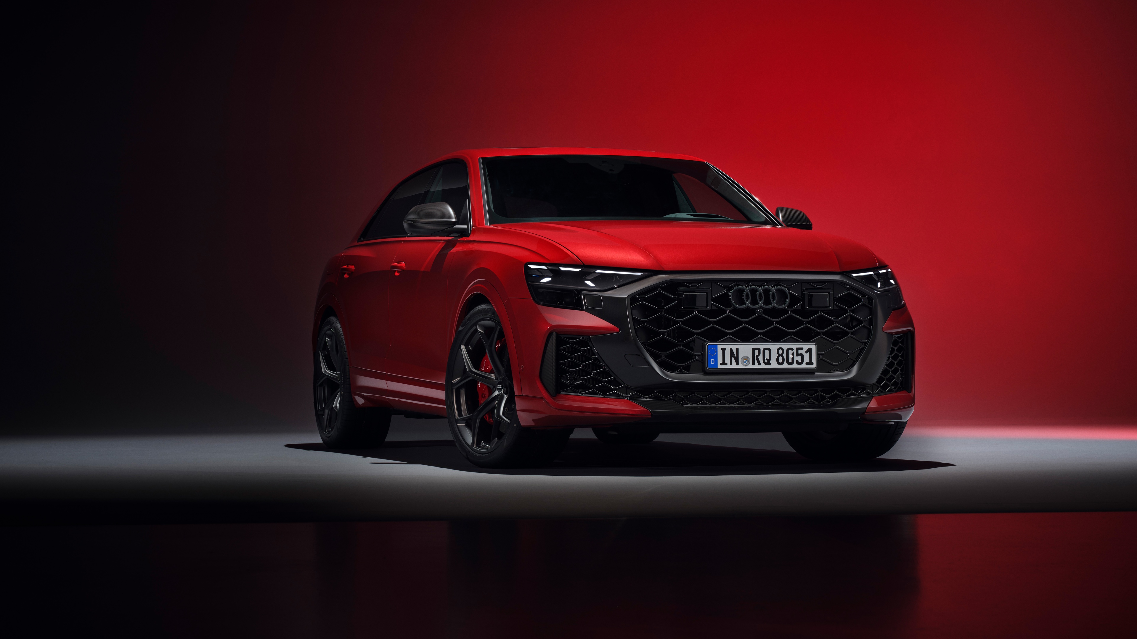 A high-resolution, detailed shot of a vibrant red 2024 Audi RS Q8 Performance luxury SUV.