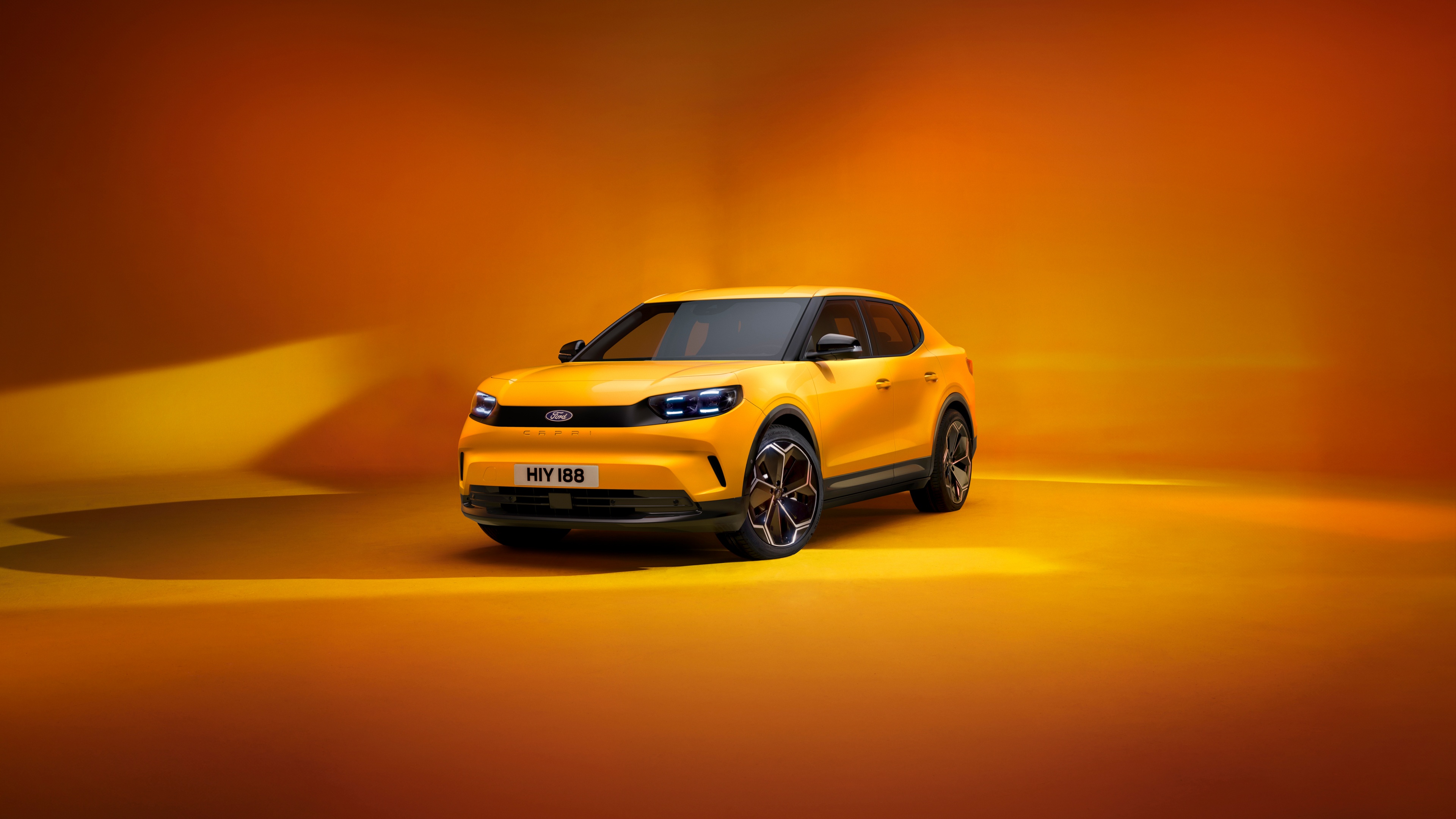 A sleek 2024 Ford Capri electric car featuring a vibrant orange color palette and modern automotive styling.