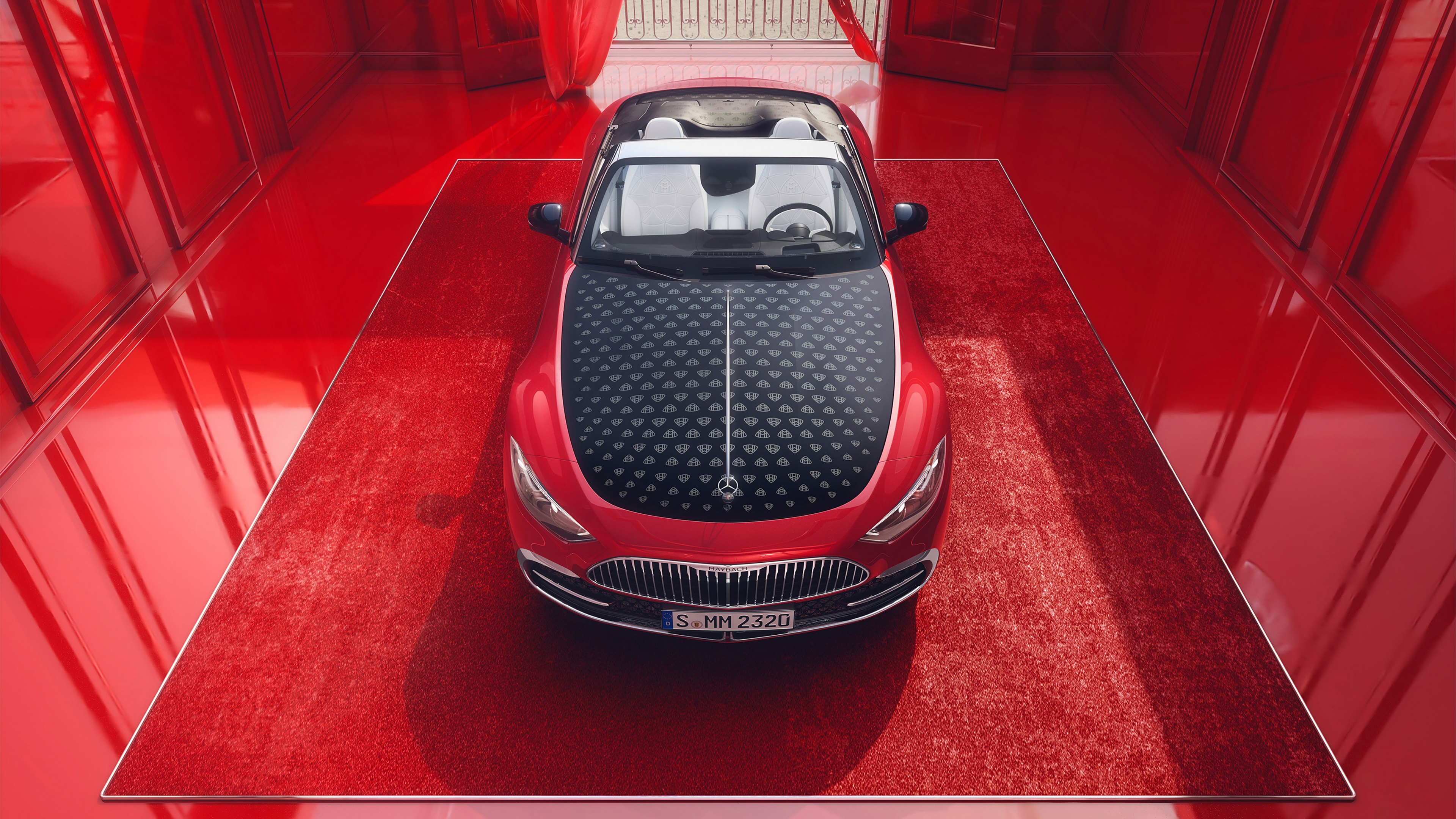A luxurious 2024 Mercedes-Maybach SL 680 presented in a deep, vibrant red aesthetic.
