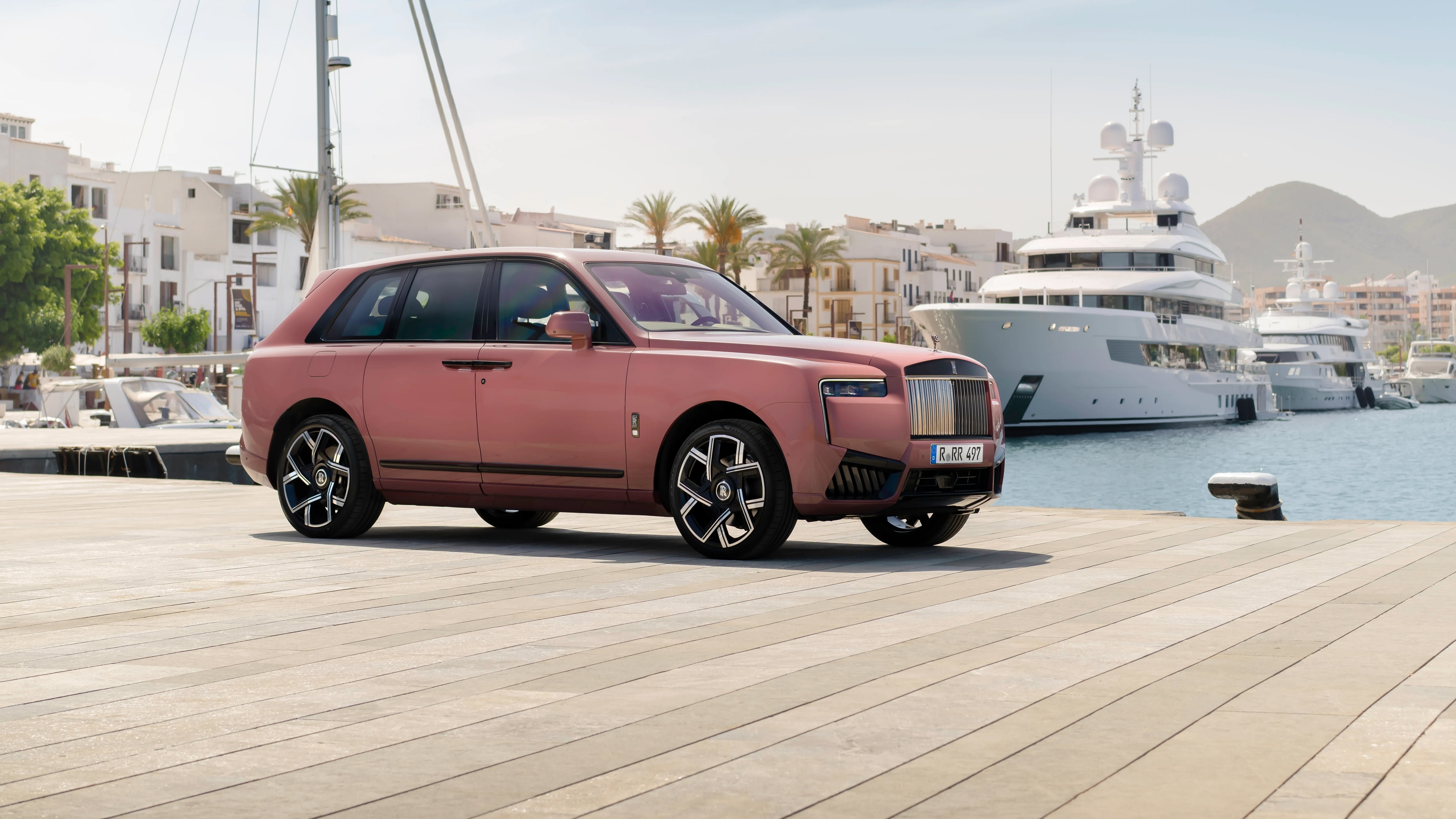 A high-resolution, cinematic shot of the 2024 Rolls-Royce Cullinan Black Badge luxury SUV featuring a sleek black finish.