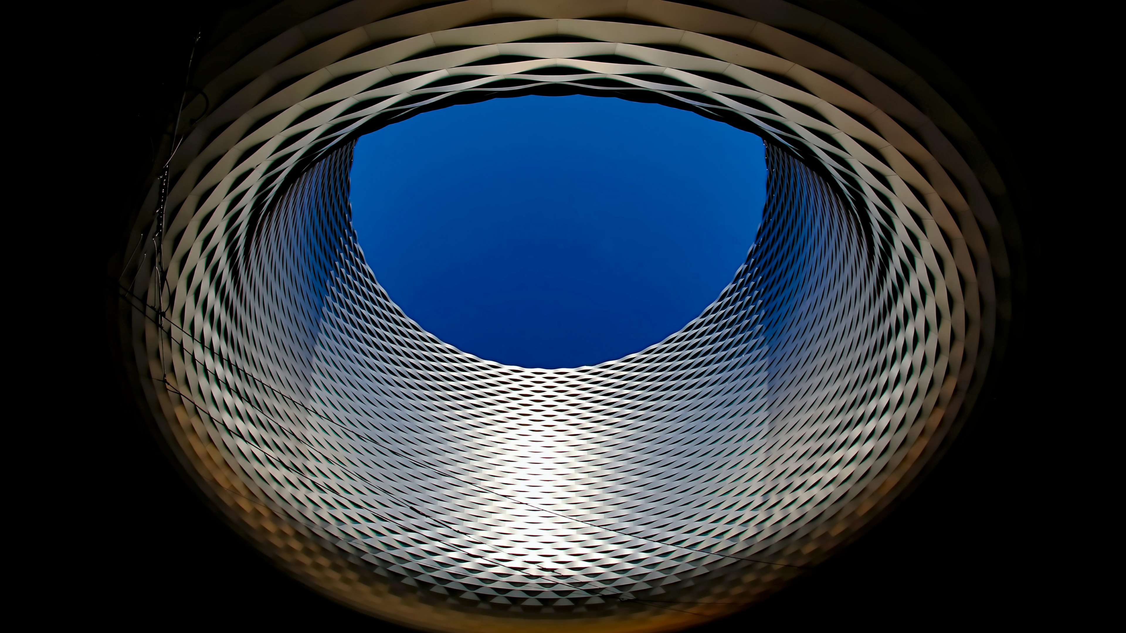 A high-angle, sky view of the modern architecture of the Basel exhibition center in Switzerland at night.