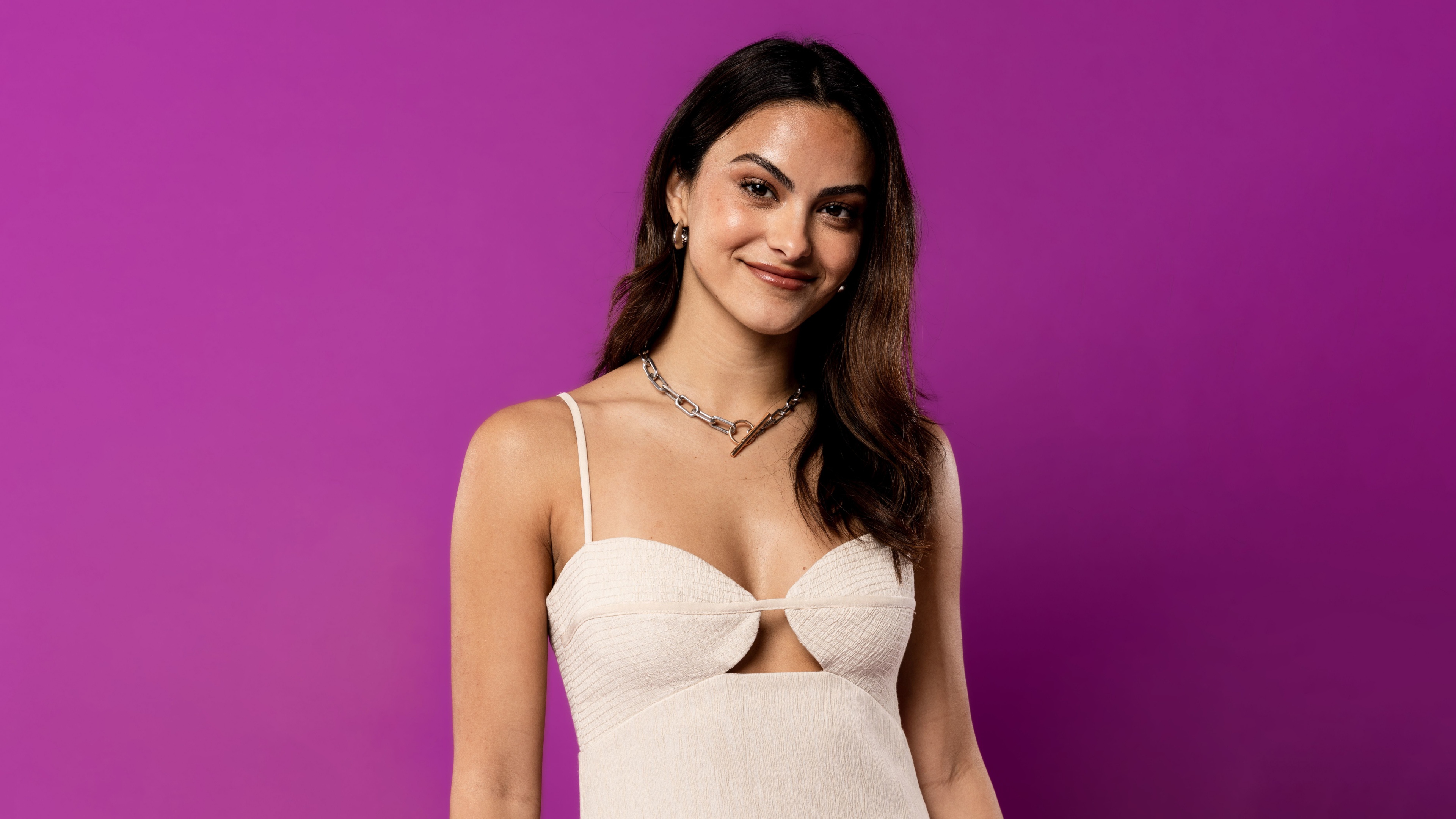 A high-definition, detailed portrait of Camila Mendes against a solid purple background.