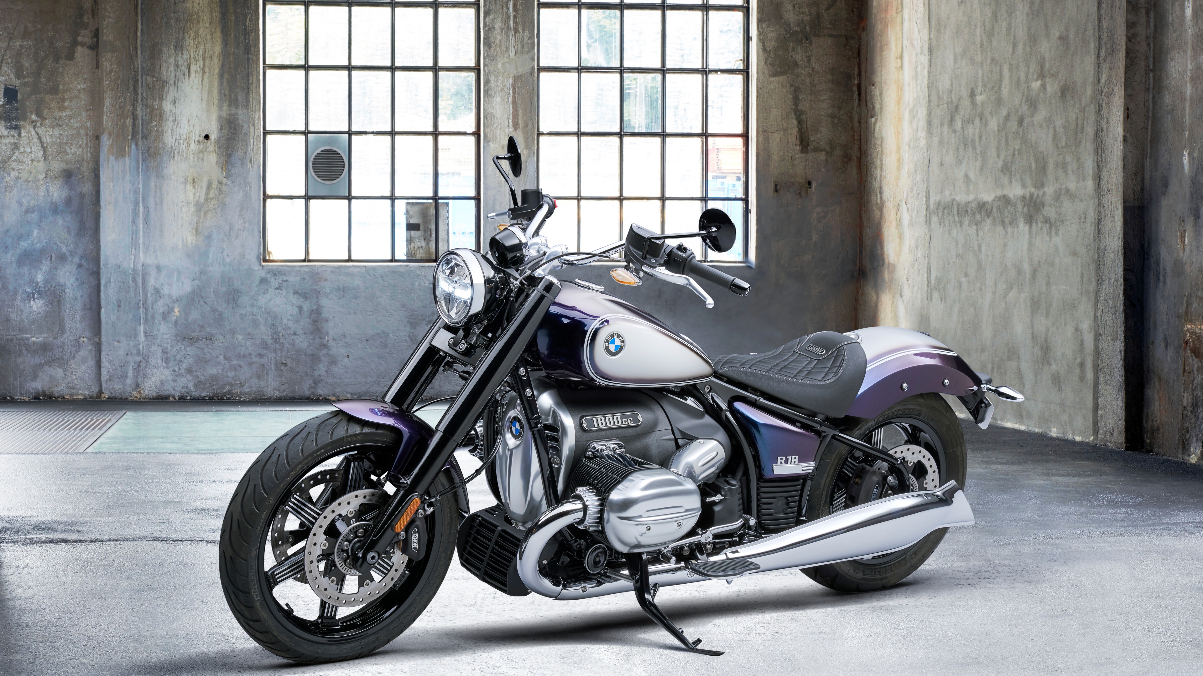 A high-resolution close-up of a custom motorcycle featuring polished chrome and dark metallic components.