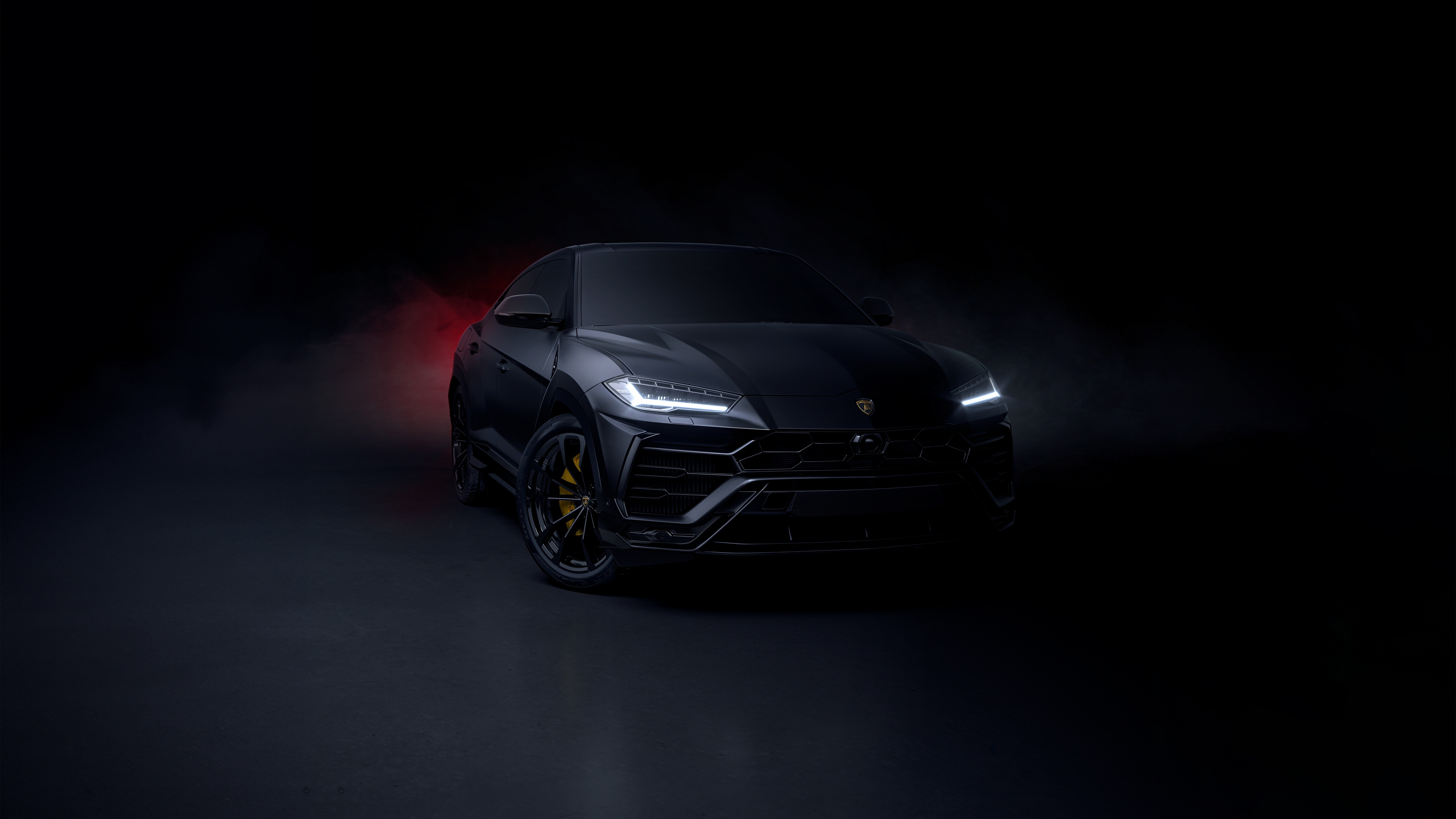 A sleek Lamborghini Urus SUV captured in a dark, cinematic style with dramatic lighting and a black aesthetic.
