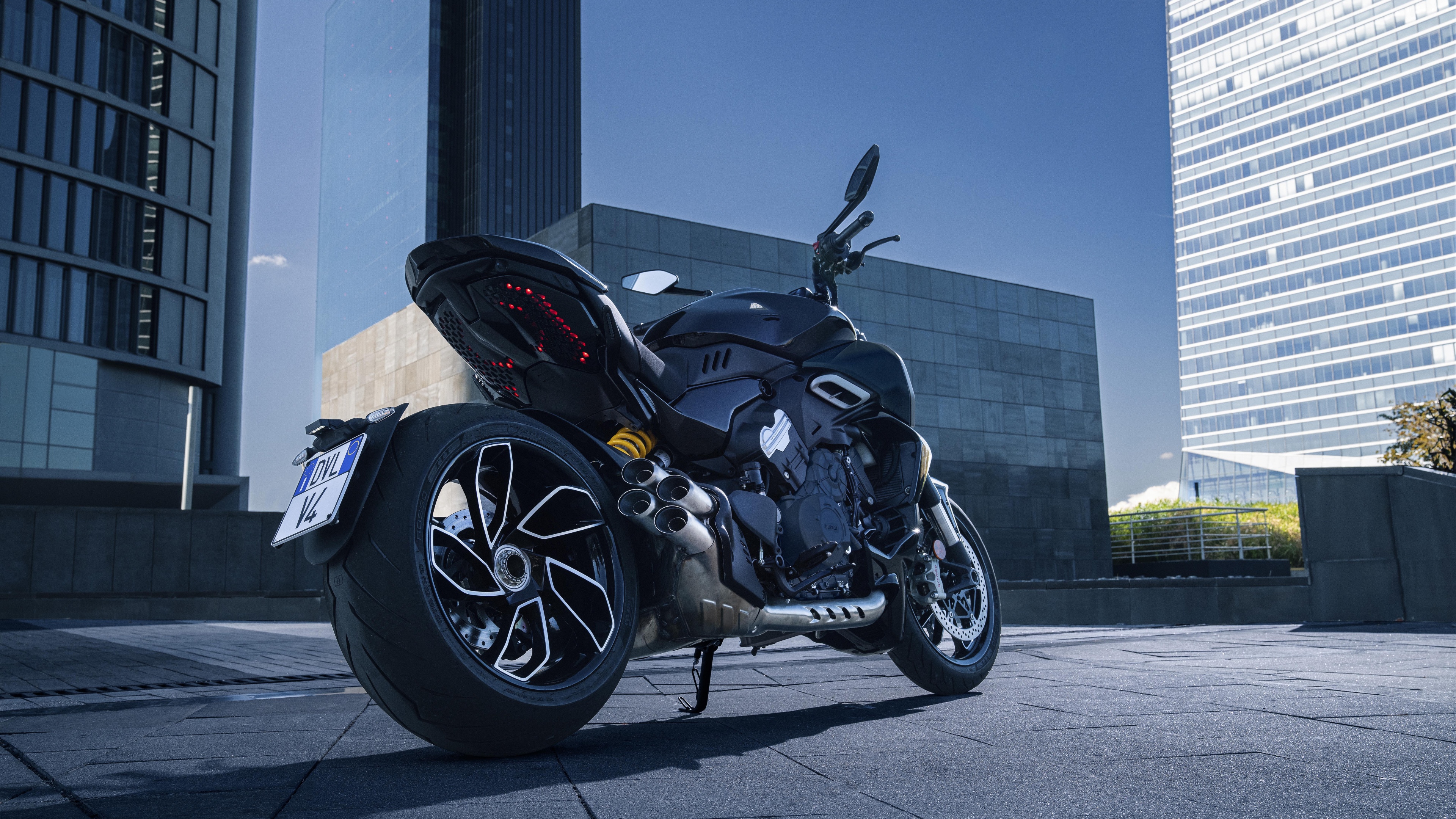 A highly detailed, close-up view of a 2023 Ducati Diavel V4 motorcycle, showcasing its muscular design and sport bike features.