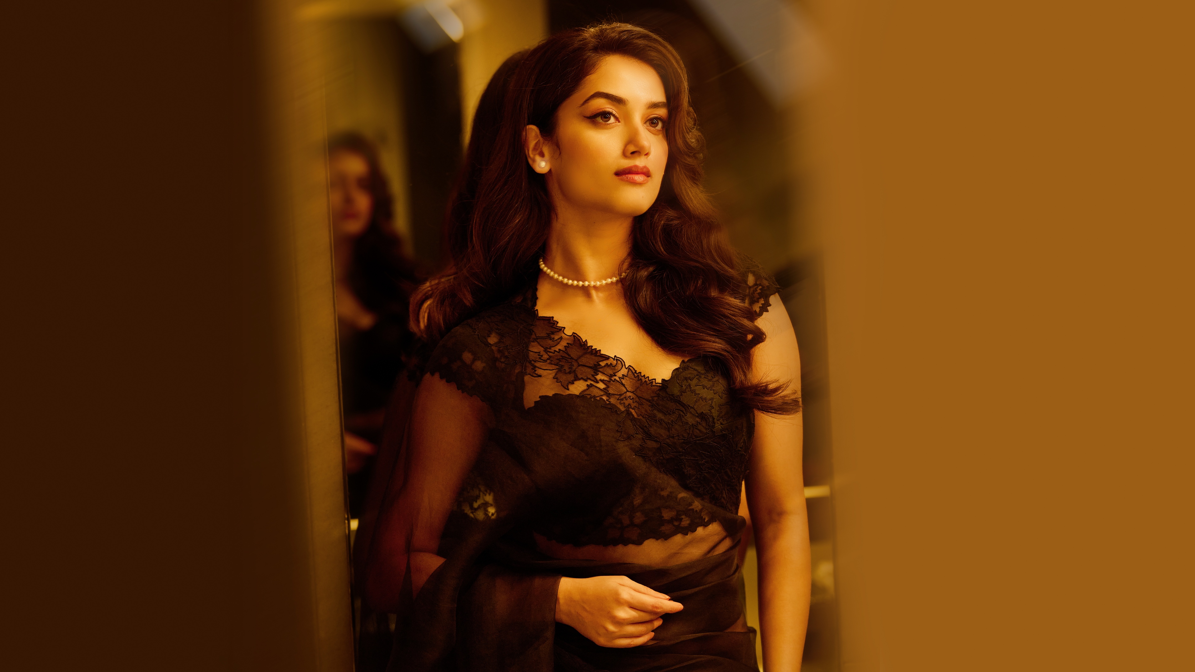 Indian actress Bhagyashri Borse posing in a stunning black saree, highlighting traditional Indian fashion and ethnic elegance.