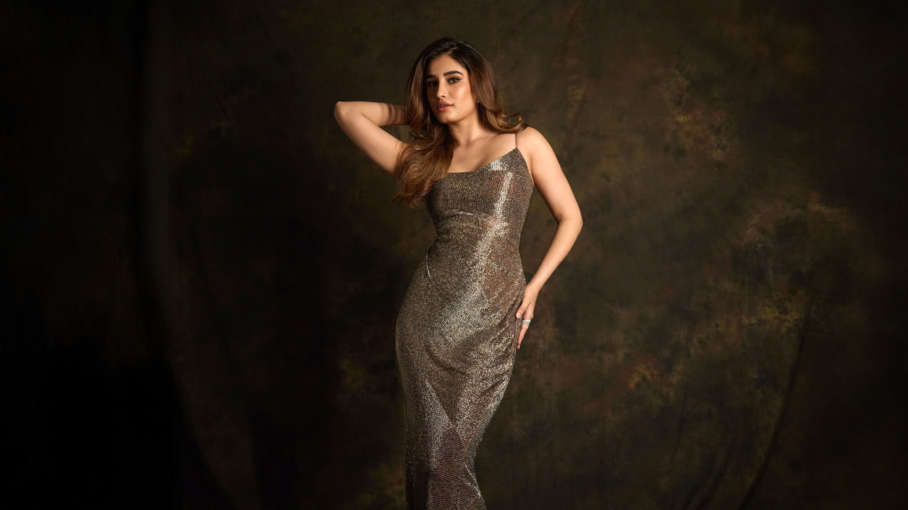 A beautiful Indian actress posing in elegant traditional Indian clothing and jewelry.