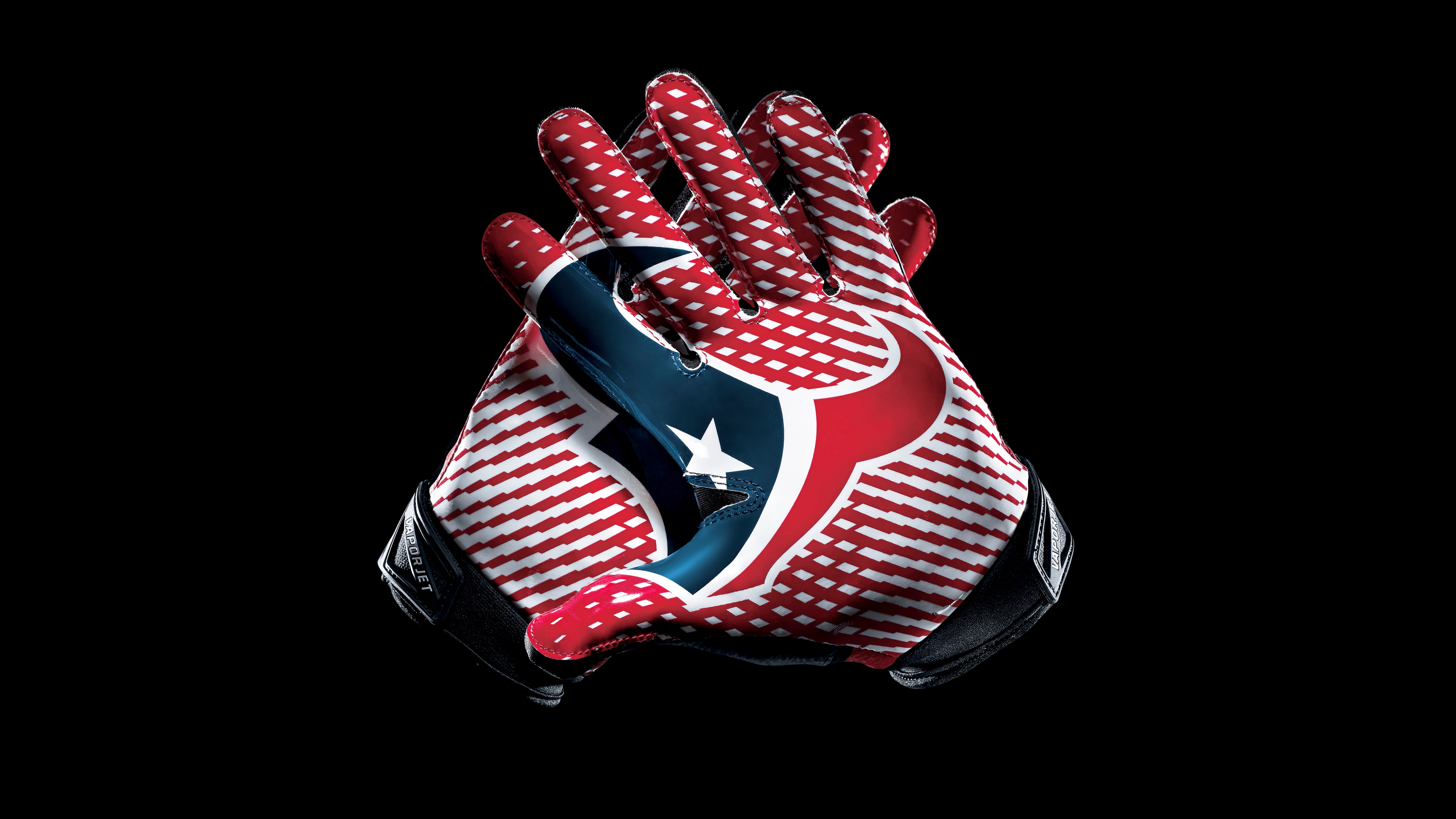 Close-up shot of Houston Texans football gloves on a black background