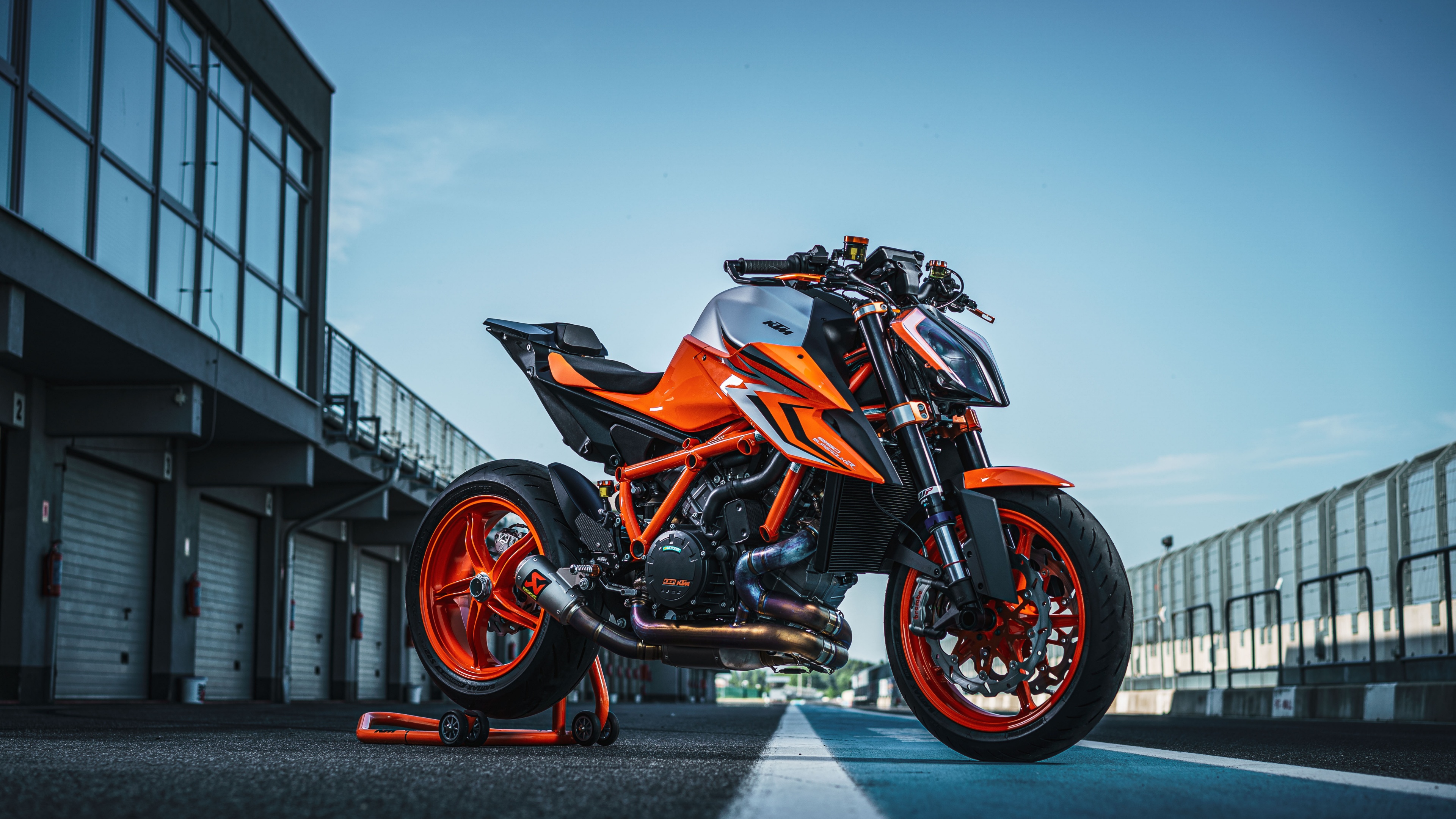 A professional shot of the KTM 1290 Super Duke R EVO 2022 naked motorcycle featuring aggressive styling and orange accents.