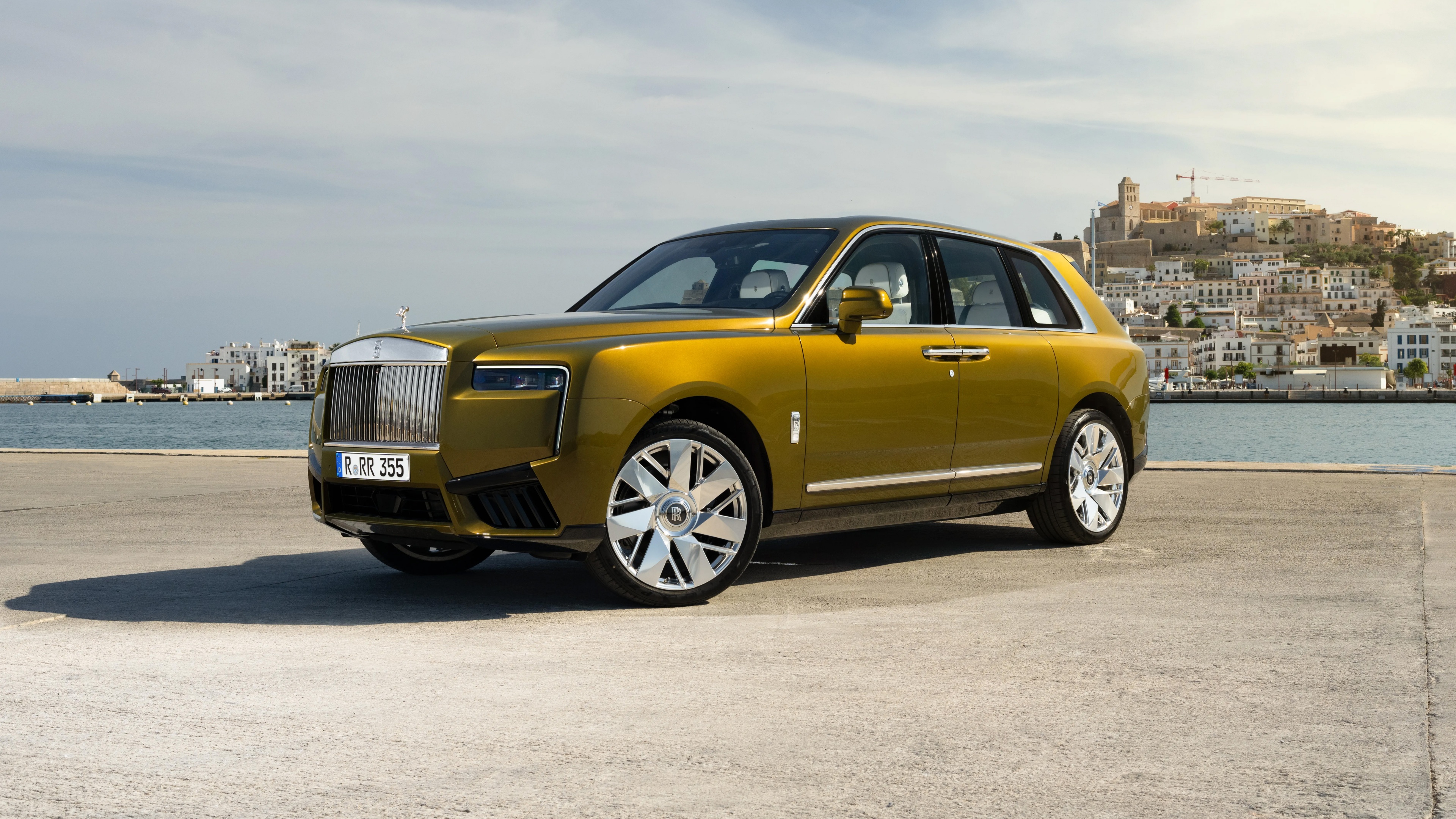 A luxurious Rolls-Royce Cullinan SUV parked on a scenic street in Monaco.