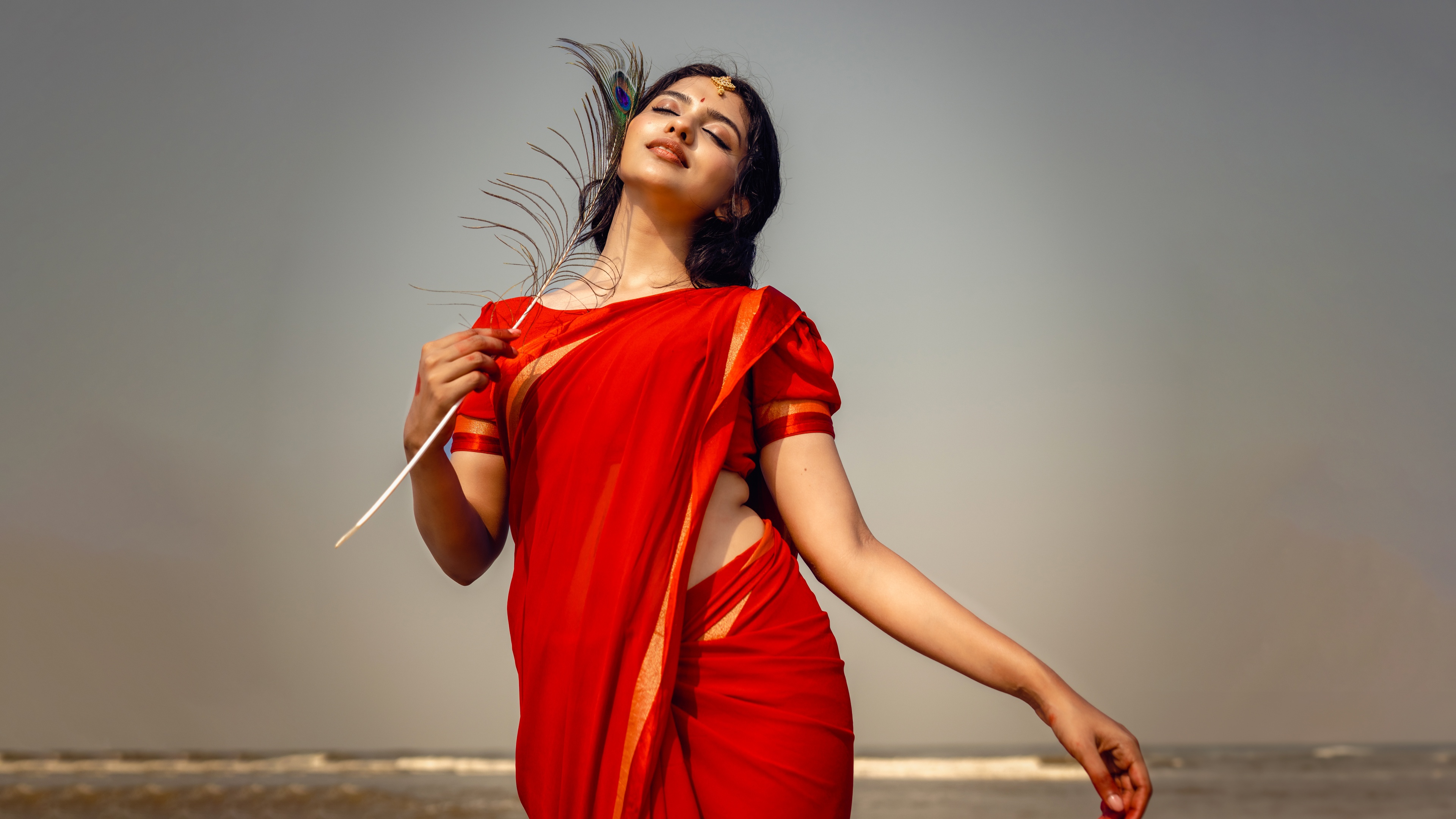 A high-resolution portrait of Indian actress Mamitha Baiju wearing a traditional saree.