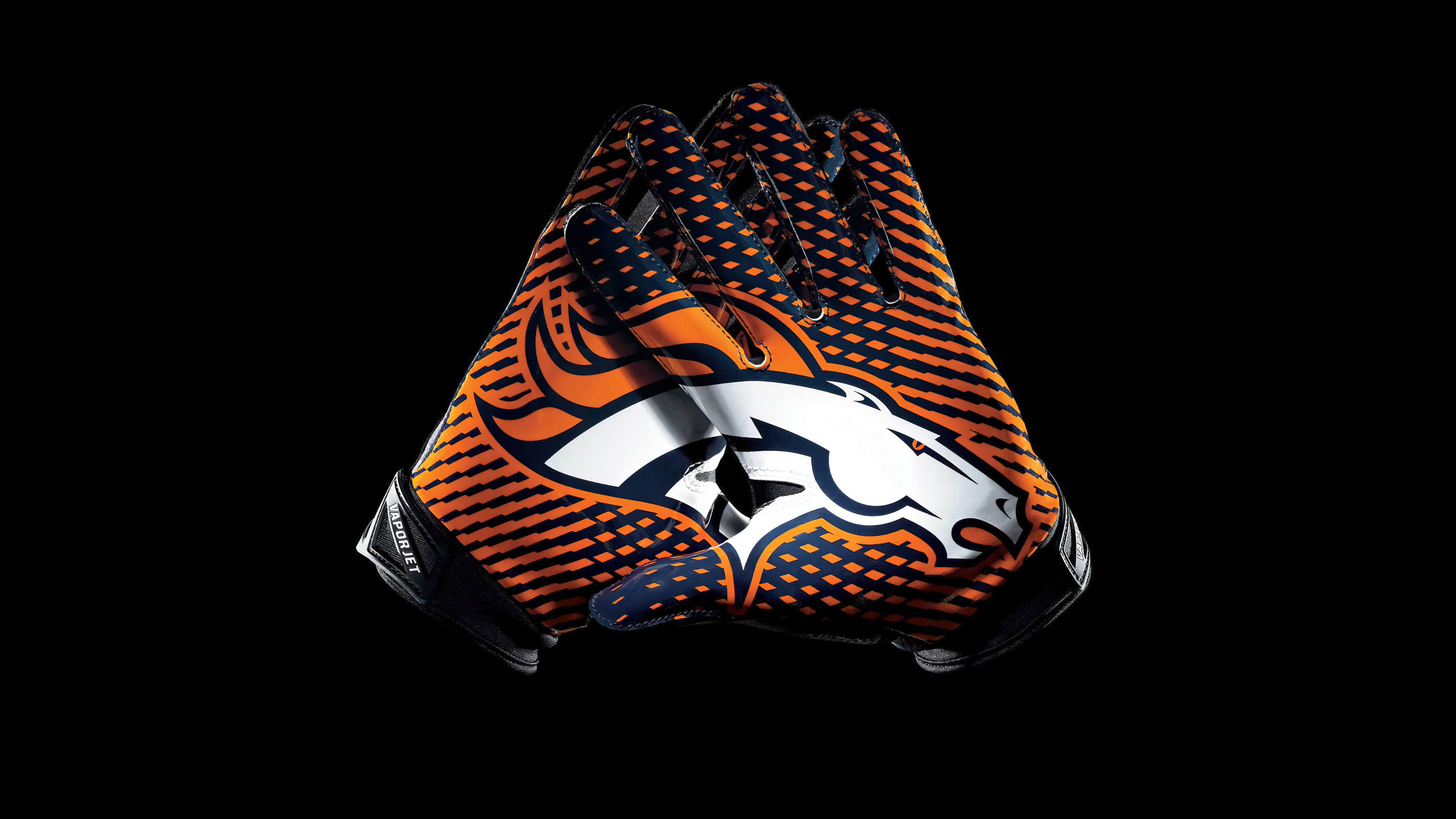 Miles the Mascot of the Denver Broncos wearing gloves against a solid black background.