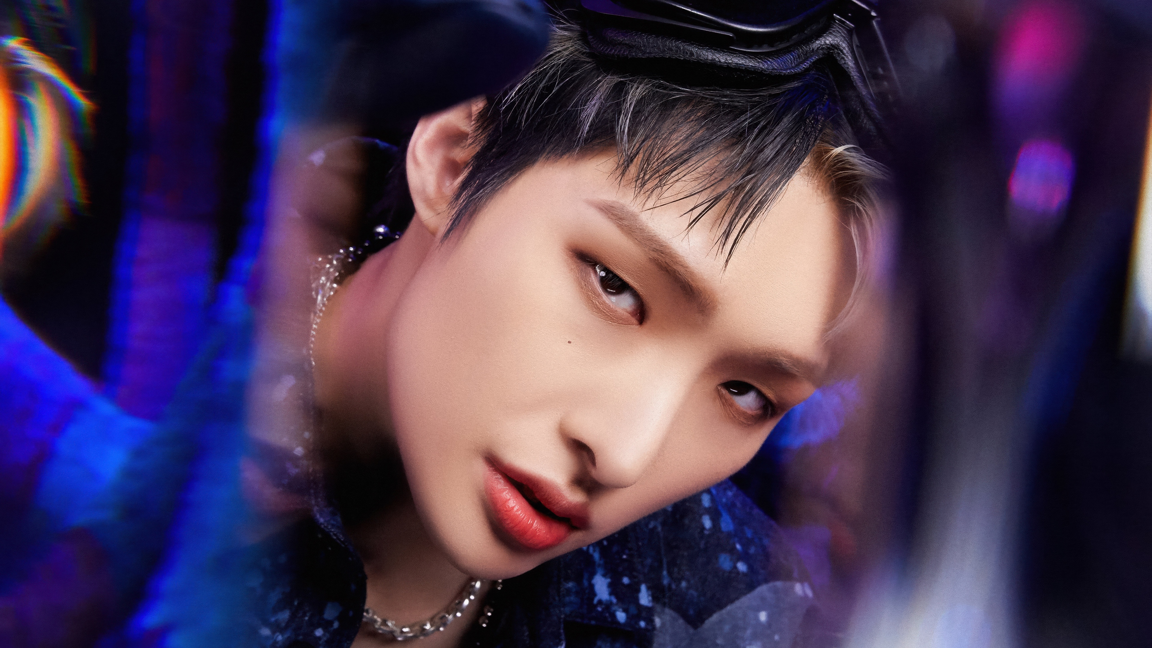 A close-up portrait of K-pop idol Mingi from ATEEZ surrounded by glowing neon lights in a futuristic style.