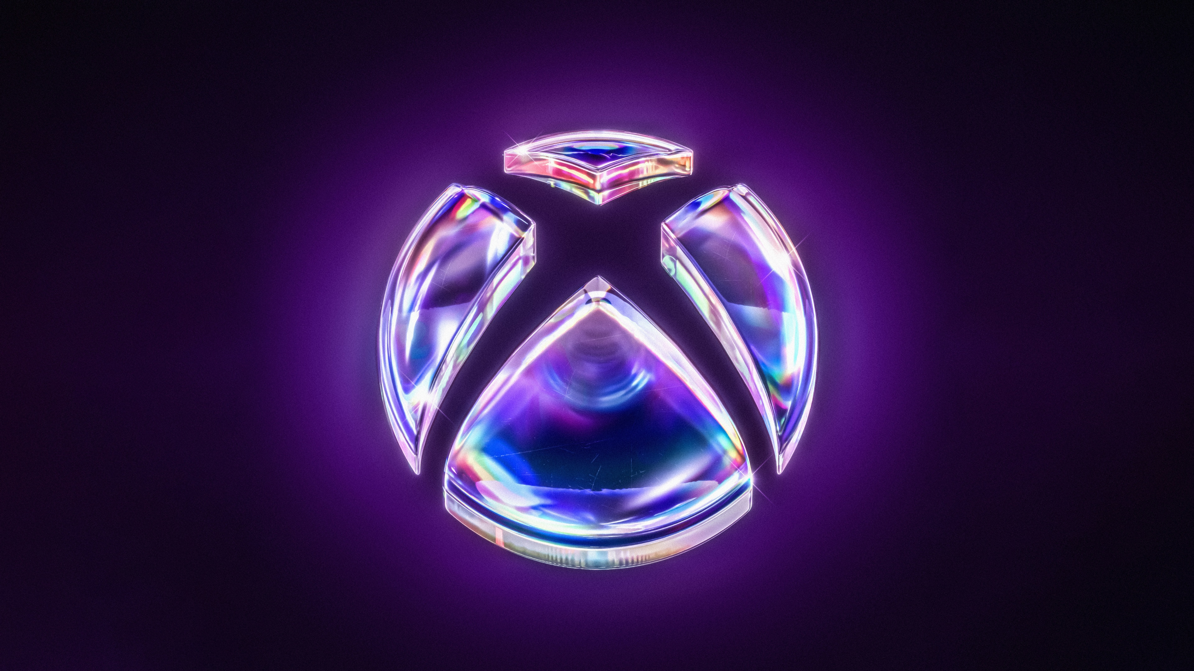 The Xbox logo prominently displayed on a dark purple, wide-format background.