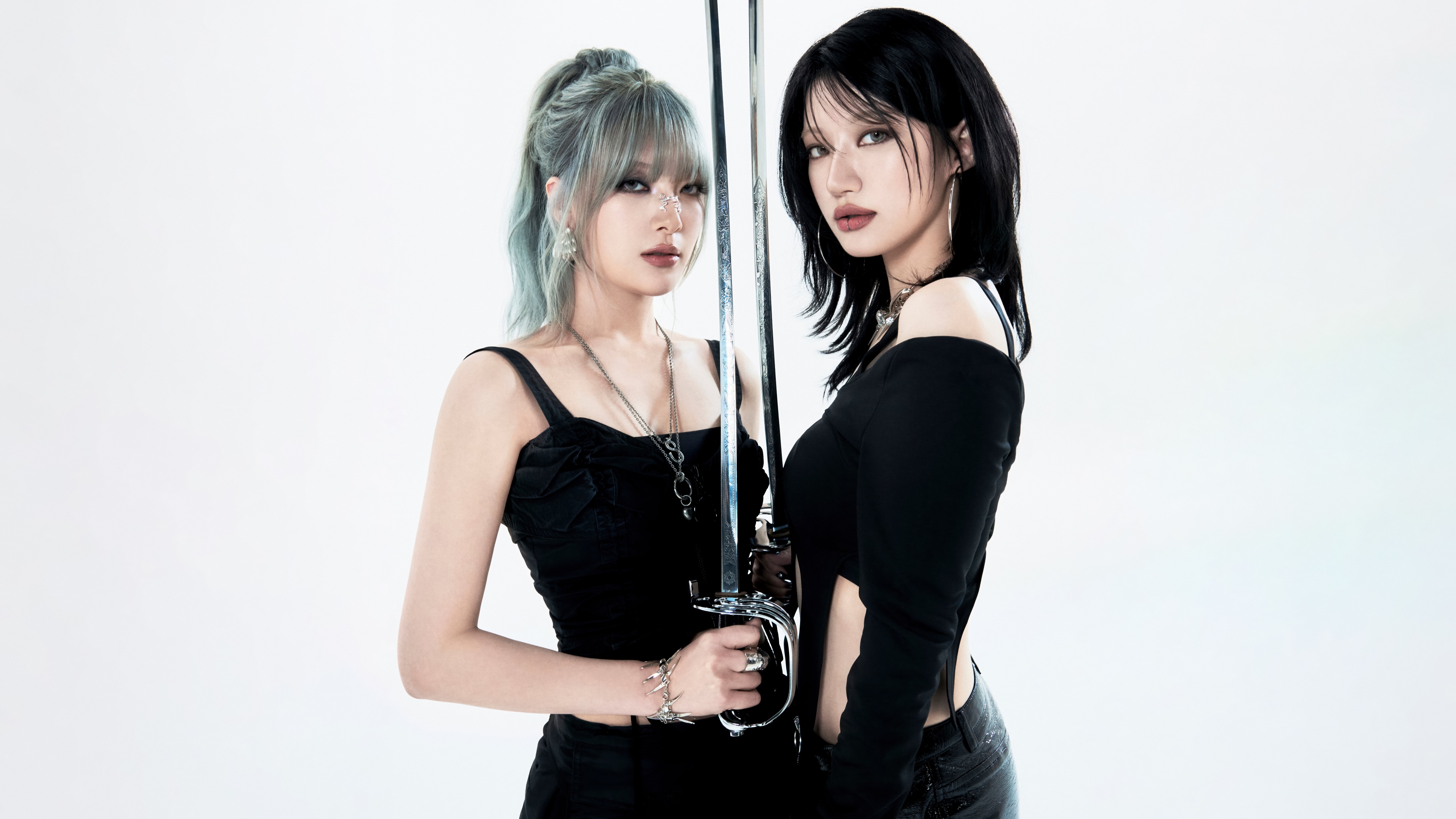 Professional studio portrait of South Korean K-pop artists Moon Sua and Siyoon from tripleS on a white background.